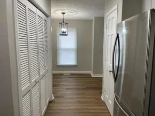 a view of hallway with stairs and wooden floor