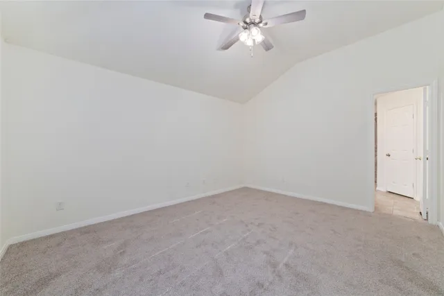 a view of an empty room with a fan