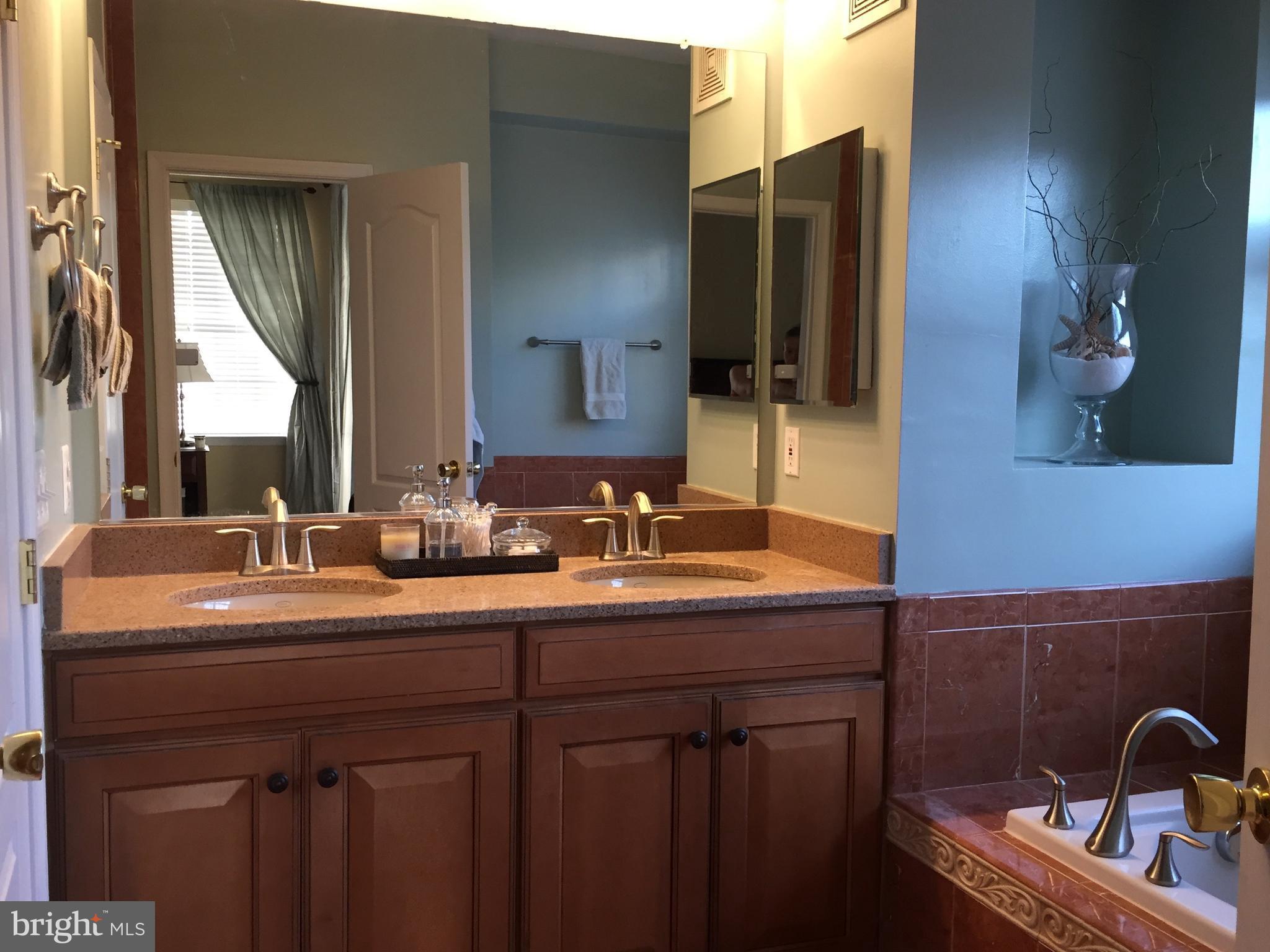 12432 Liberty Bridge Road, Unit A Fairfax, VA 22033 - Photo 12 of 14 a bathroom with a double vanity sink and a mirror