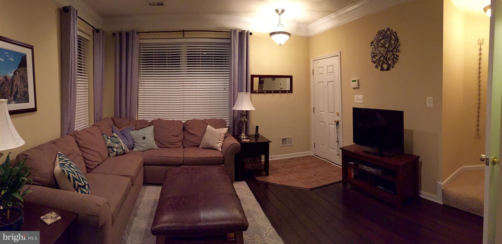 12432 Liberty Bridge Road, Unit A Fairfax, VA 22033 - Photo 3 of 14 a living room with furniture and a flat screen tv