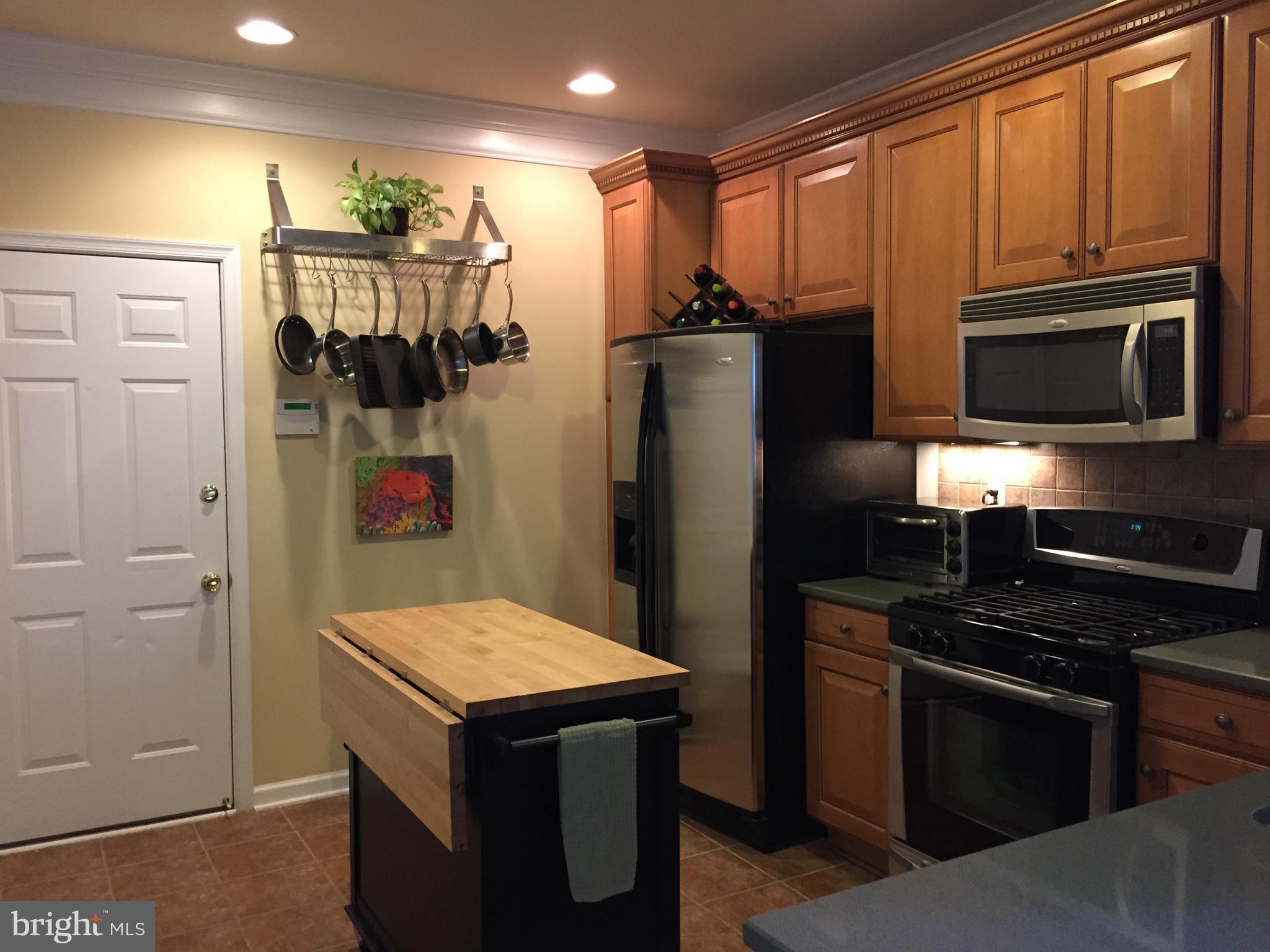 12432 Liberty Bridge Road, Unit A Fairfax, VA 22033 - Photo 4 of 14 a kitchen with stainless steel appliances granite countertop a refrigerator and a stove top oven