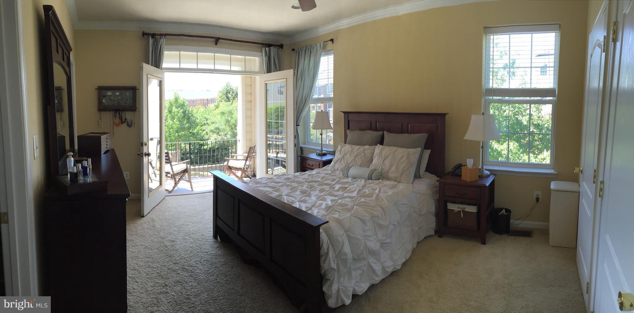12432 Liberty Bridge Road, Unit A Fairfax, VA 22033 - Photo 7 of 14 a bed sitting in a bedroom next to a window