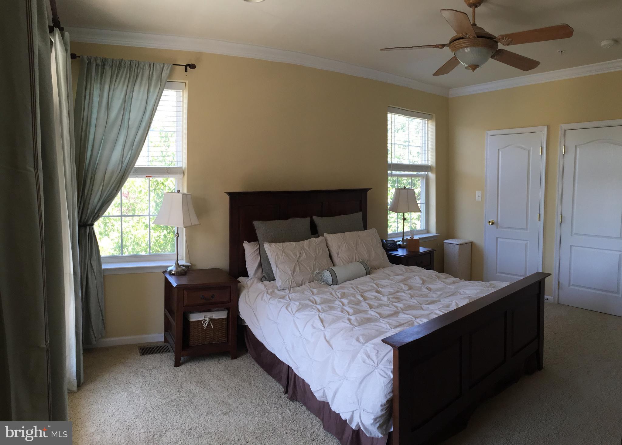 12432 Liberty Bridge Road, Unit A Fairfax, VA 22033 - Photo 8 of 14 a bedroom with a bed and a window