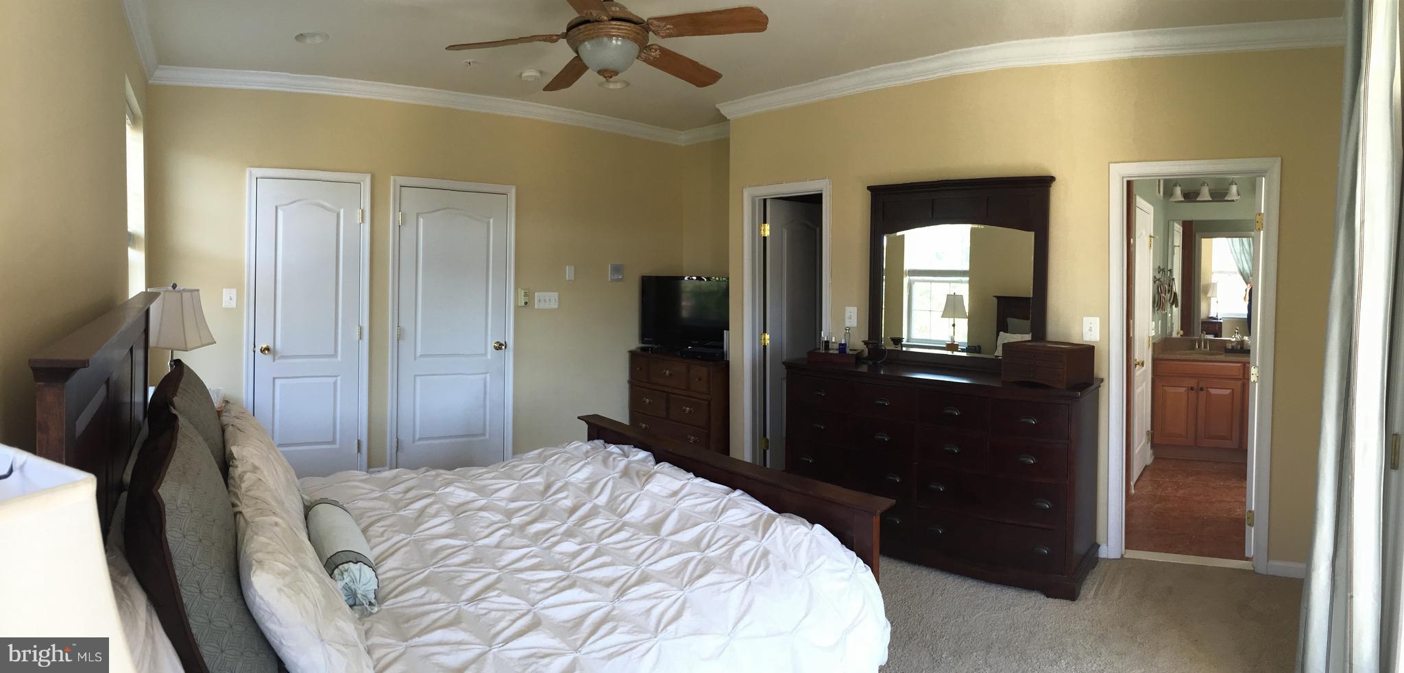 12432 Liberty Bridge Road, Unit A Fairfax, VA 22033 - Photo 9 of 14 a bedroom with a bed and a mirror on dresser