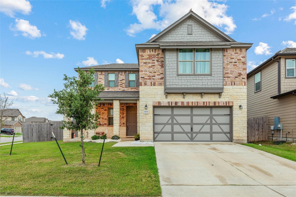 13621 Abigail Adams Street Manor, TX 78653 - Photo 1 of 1 a front view of a house with a garden and plants