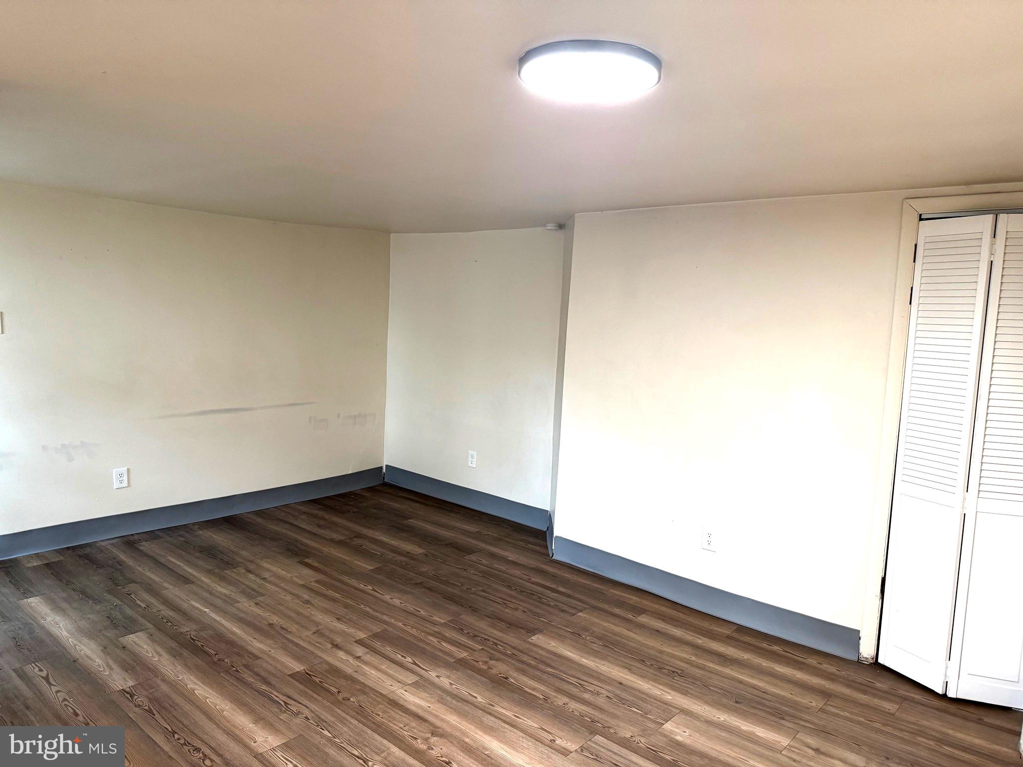 725 West Broad Street, Unit 4 Quakertown, PA 18951 - Photo 5 of 14 a view of an empty room with wooden floor