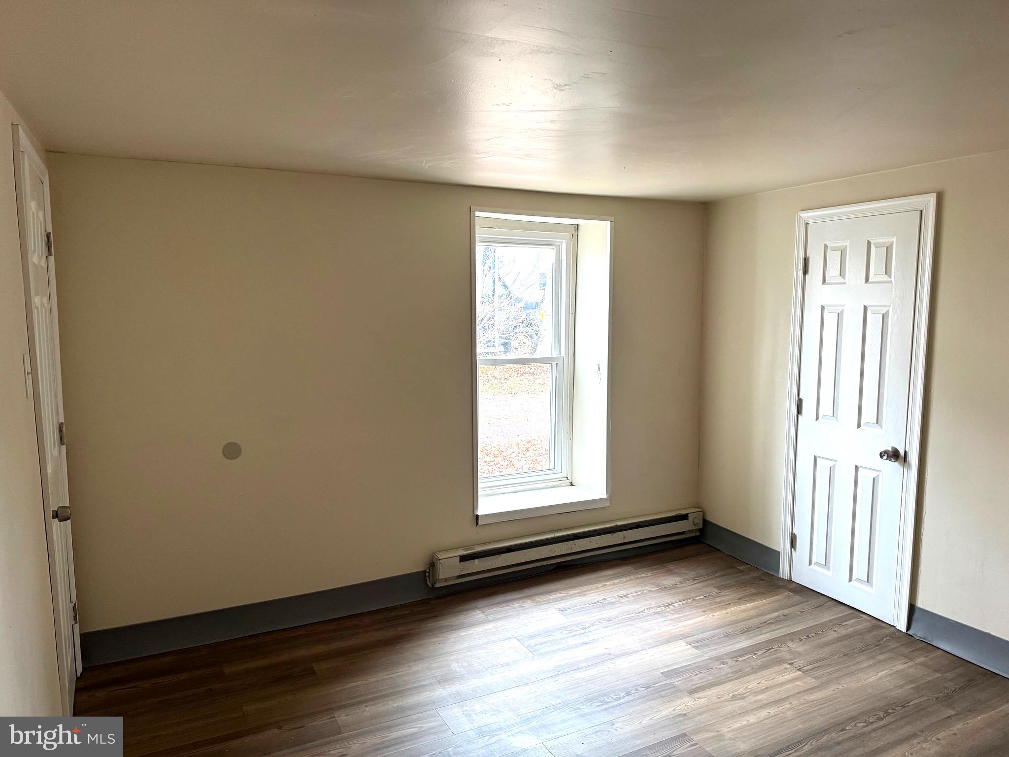 725 West Broad Street, Unit 4 Quakertown, PA 18951 - Photo 8 of 14 an empty room with wooden floor and windows