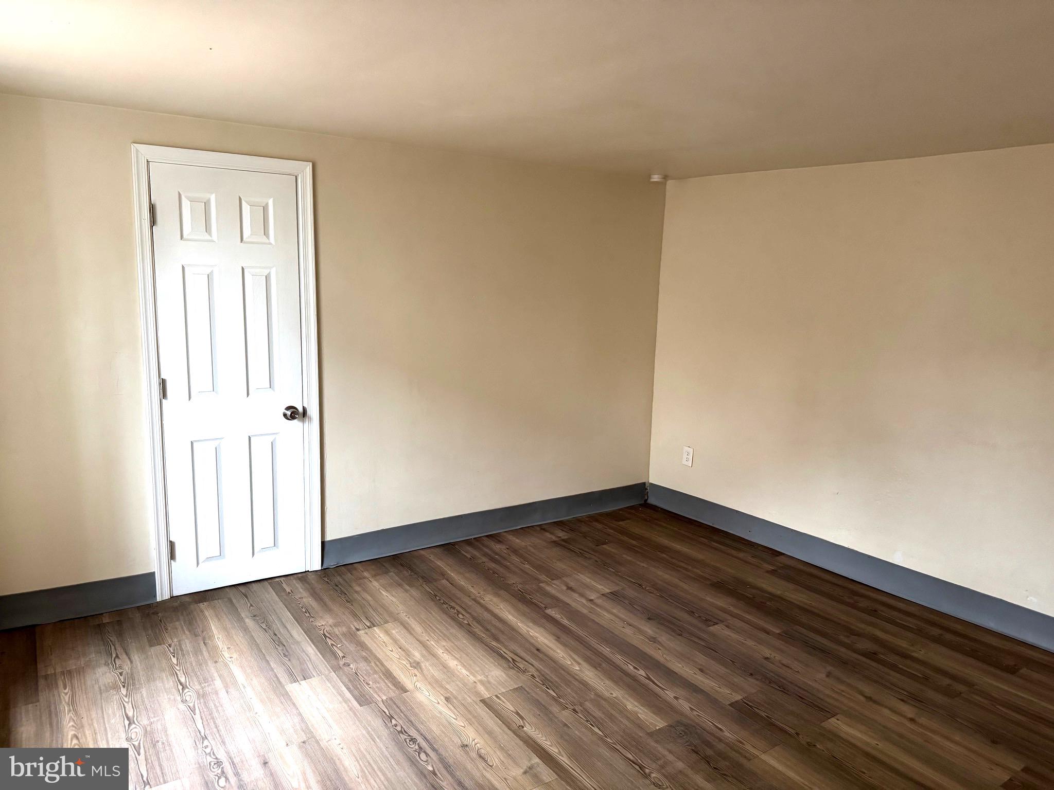 725 West Broad Street, Unit 4 Quakertown, PA 18951 - Photo 9 of 14 an empty room with wooden floor and windows