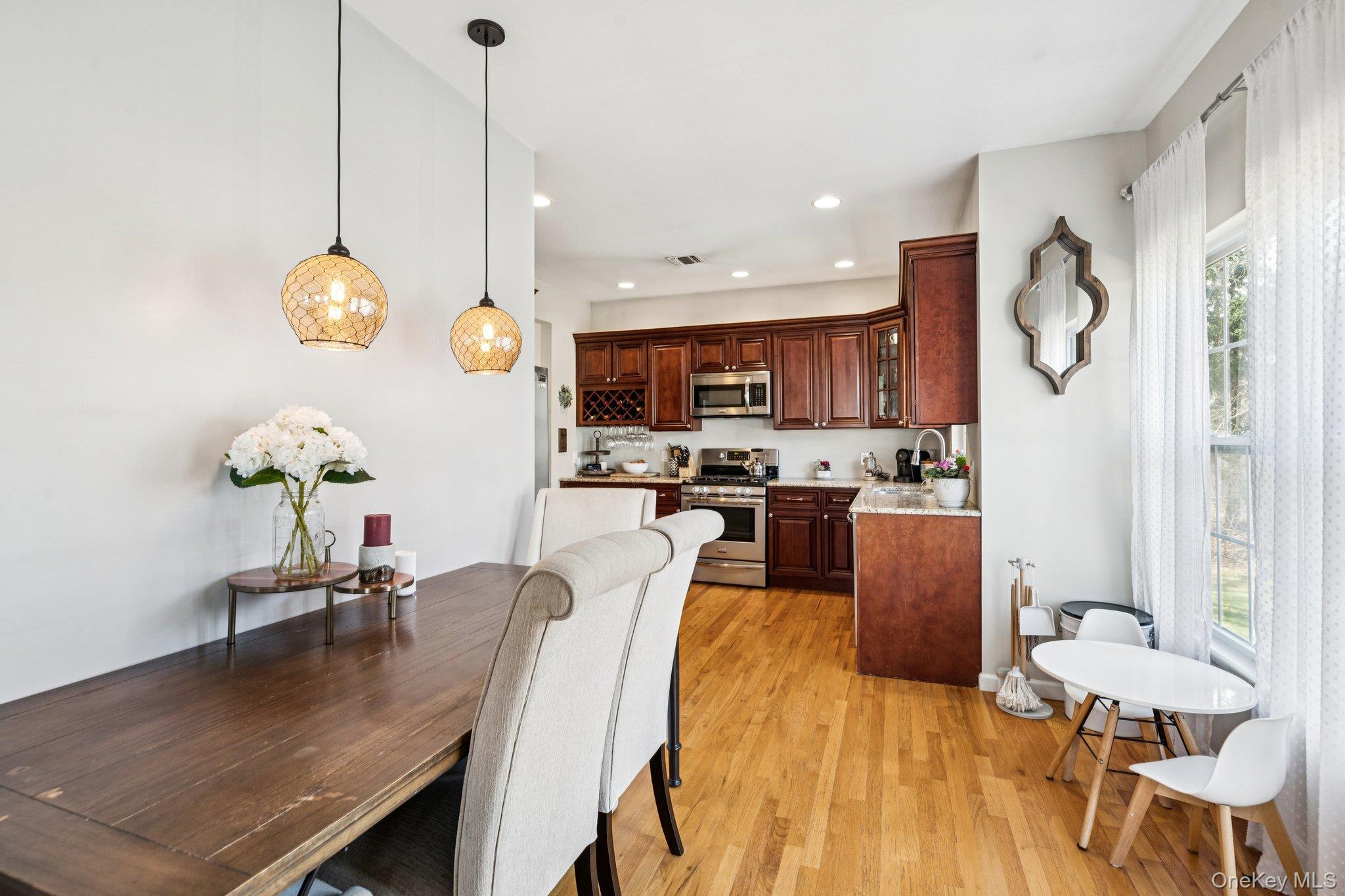 4 Clinton Avenue Bellport, NY 11713 - Photo 16 of 34 a dining room filled chandelier and wooden floor