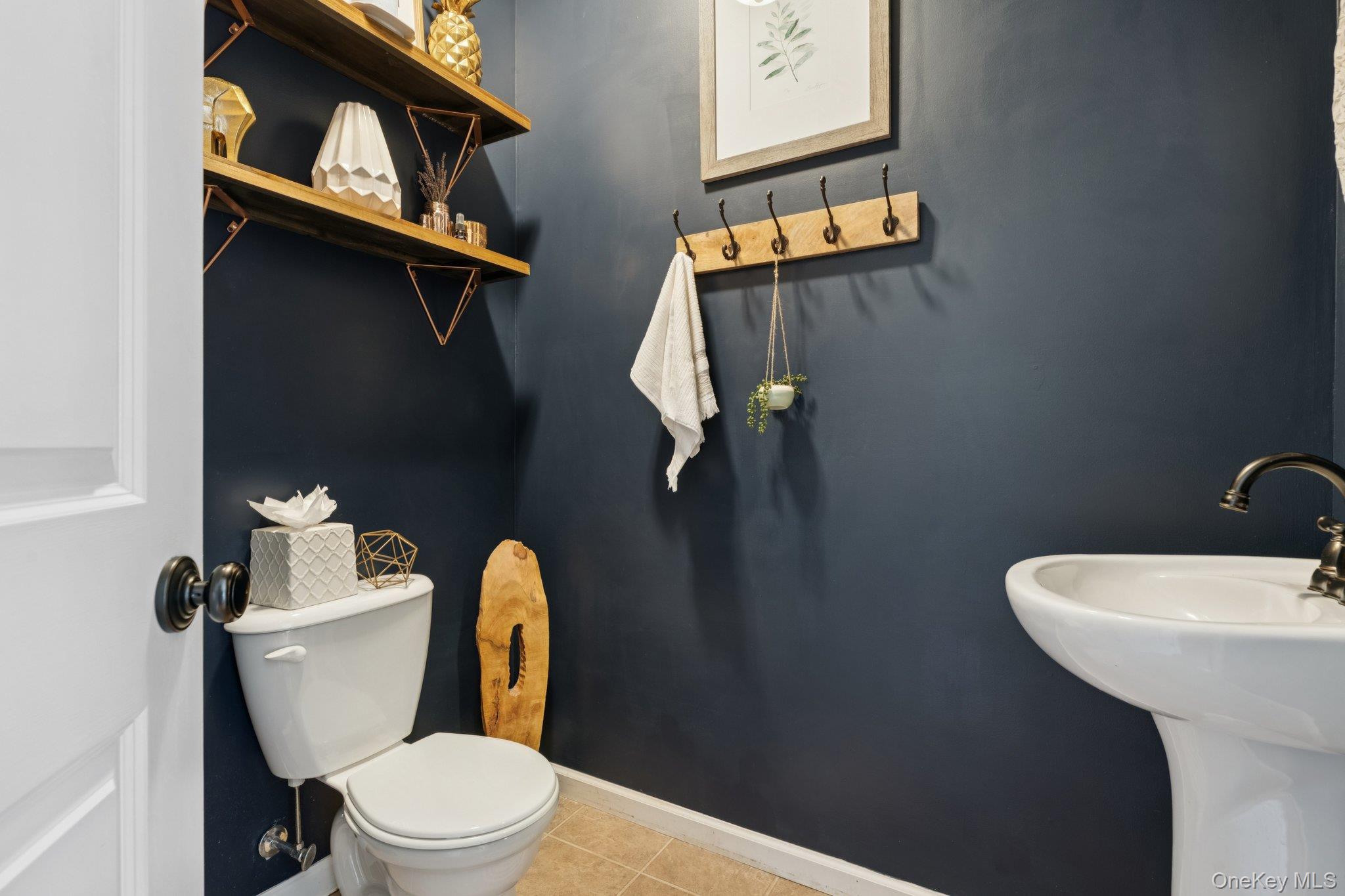 4 Clinton Avenue Bellport, NY 11713 - Photo 18 of 34 a toilet that has a toilet and a sink