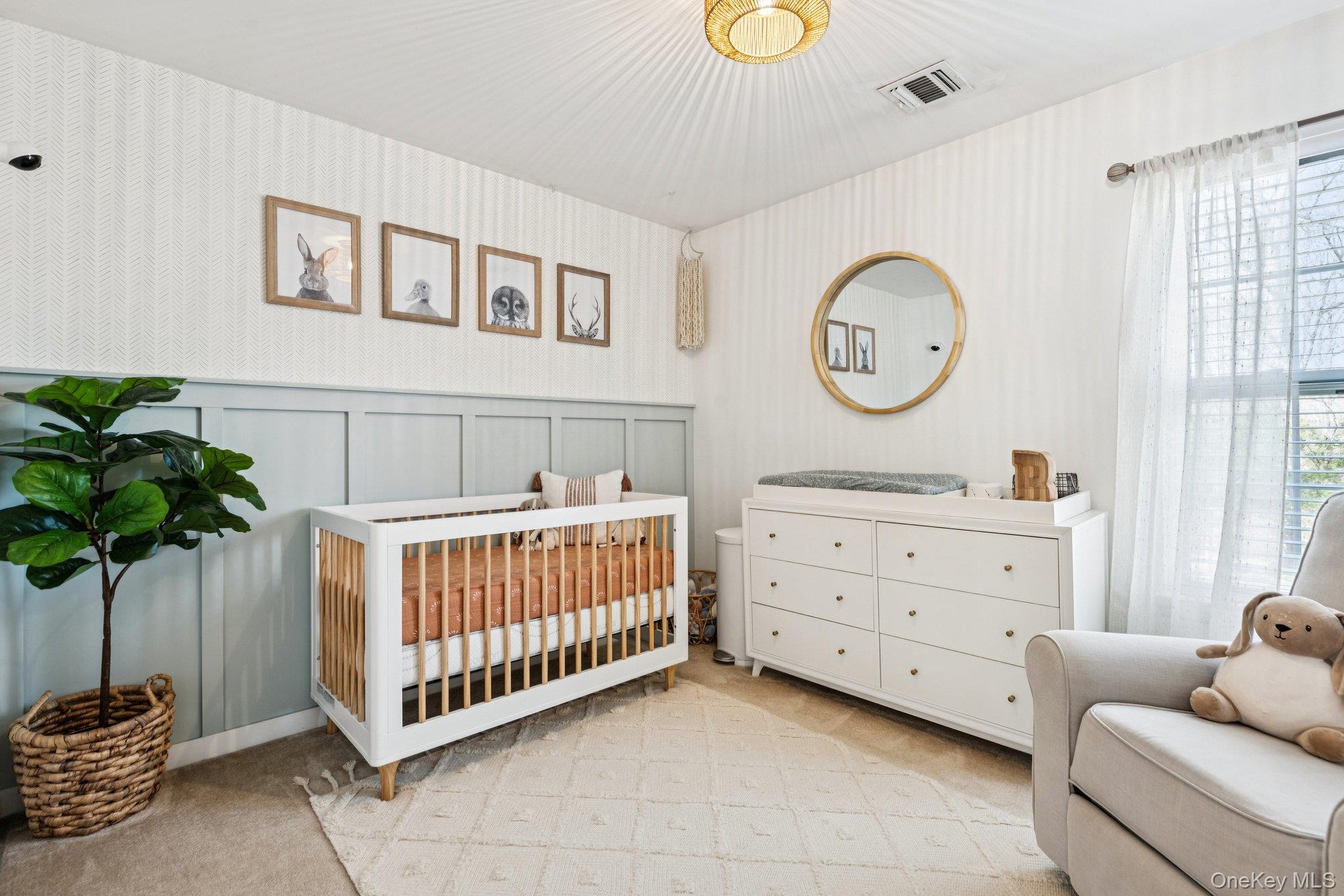 4 Clinton Avenue Bellport, NY 11713 - Photo 21 of 34 a room with a bed and a chandelier