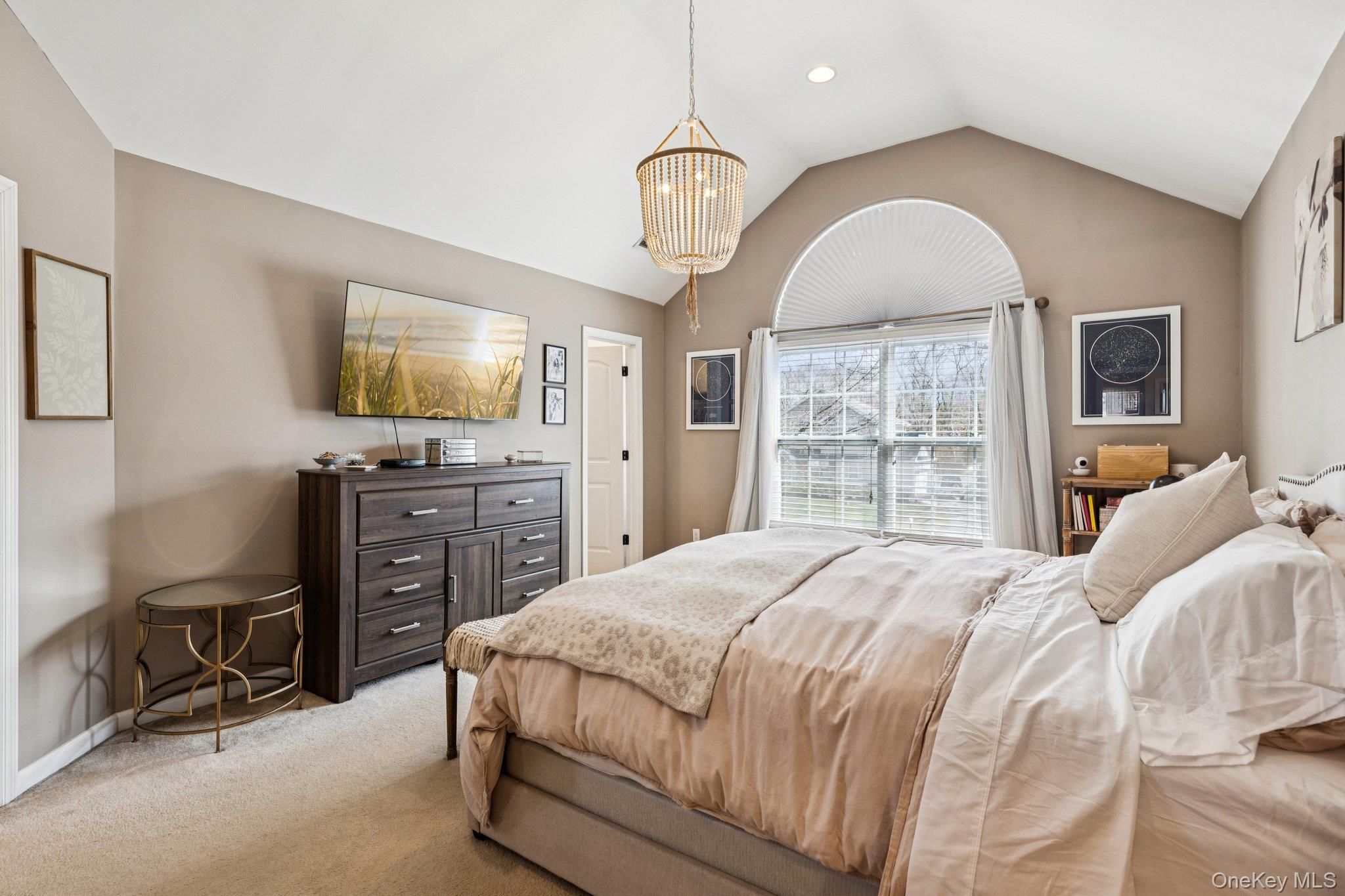 4 Clinton Avenue Bellport, NY 11713 - Photo 25 of 34 a bedroom with a bed a dresser and flat screen tv