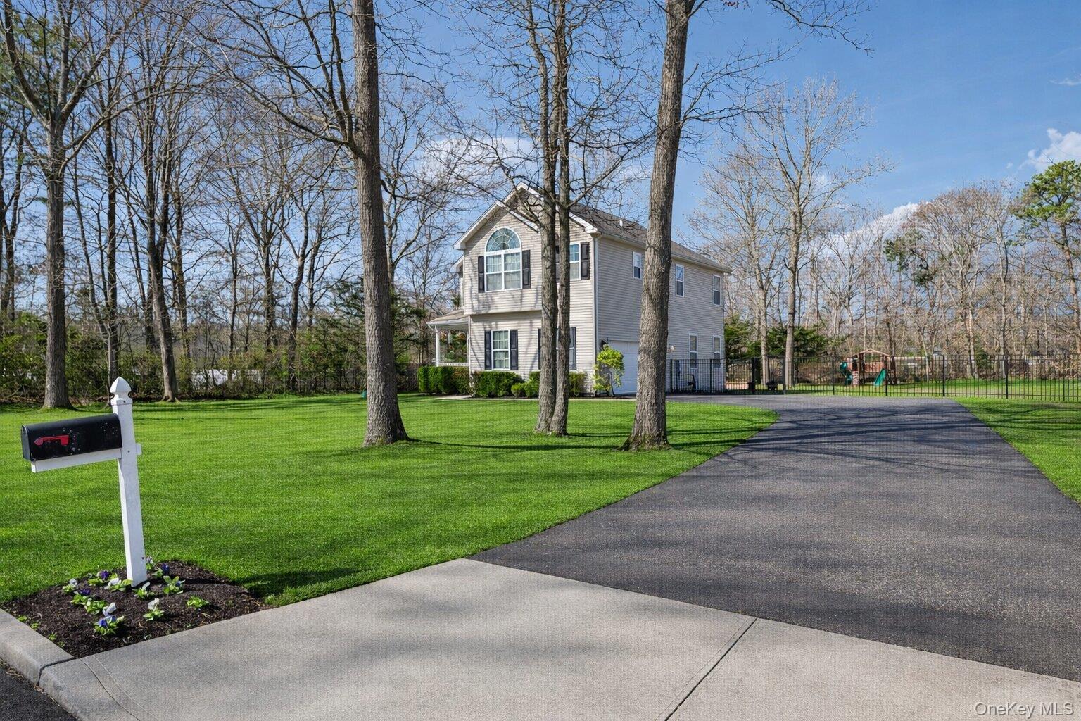 4 Clinton Avenue Bellport, NY 11713 - Photo 3 of 34 a view of a park with large trees