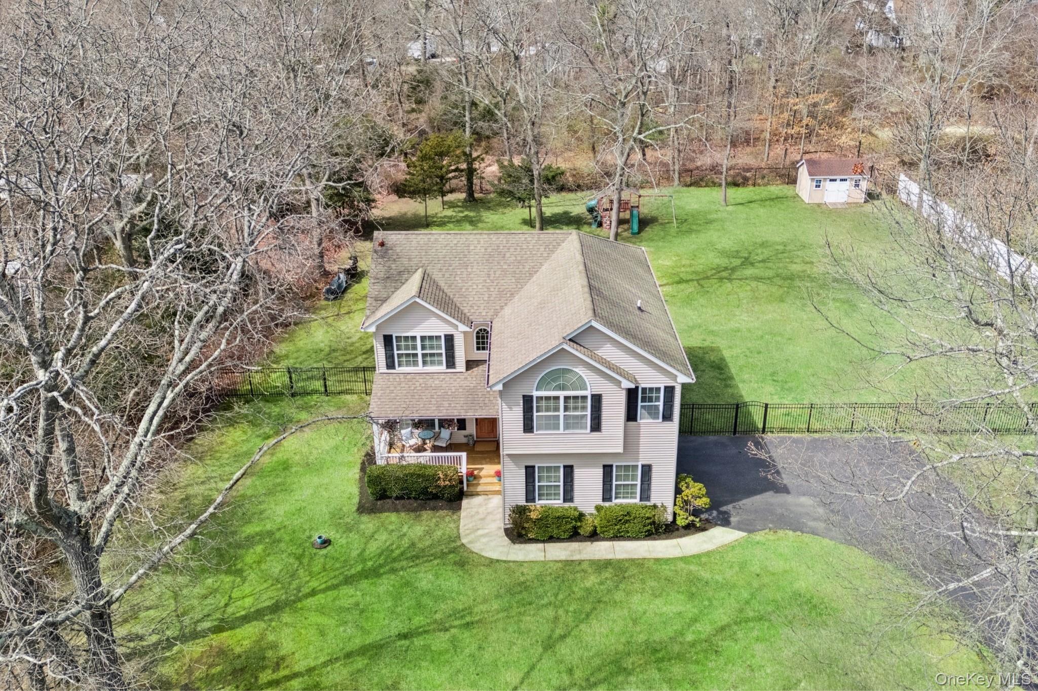 4 Clinton Avenue Bellport, NY 11713 - Photo 34 of 34 a house with green field in front of it