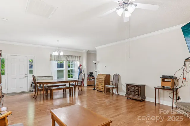a living room with fireplace furniture and a large window