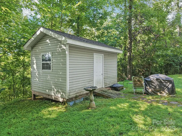 a backyard of a house with table and chairs
