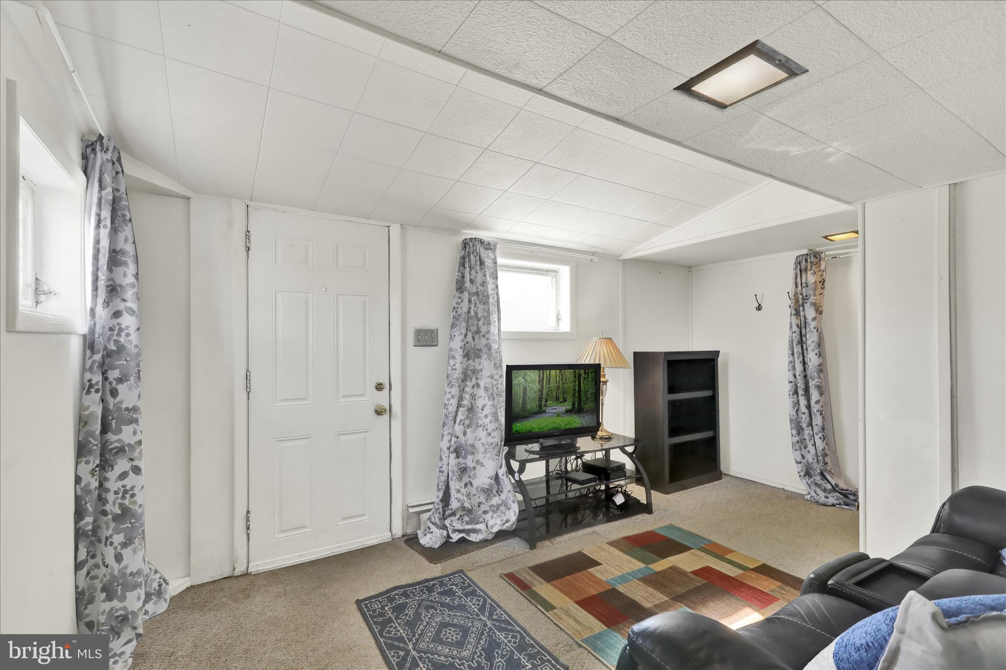 1086 Heffner Lane Reading, PA 19605 - Photo 11 of 44 a living room with furniture a flat screen tv and a window