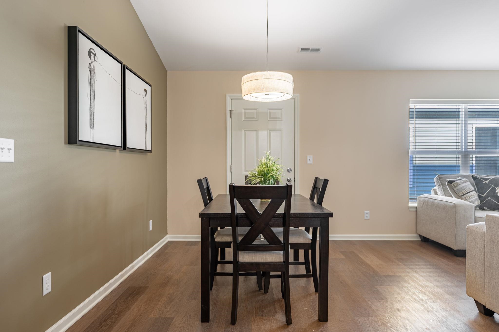 882 Fuller Lane Belvidere, IL 61008 - Photo 19 of 29 a view of a dining room with furniture and wooden floor
