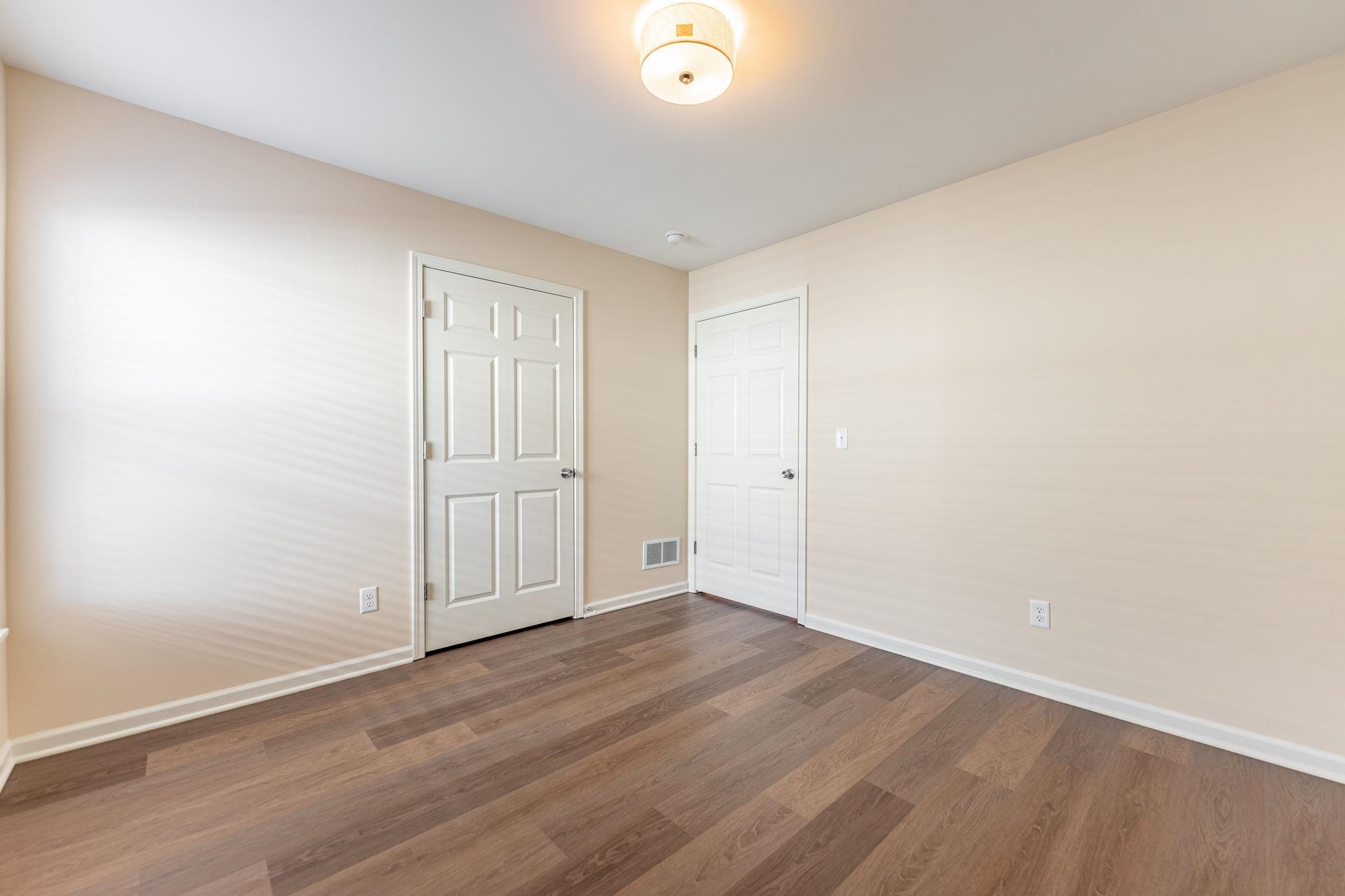 882 Fuller Lane Belvidere, IL 61008 - Photo 7 of 29 an empty room with wooden floor and windows