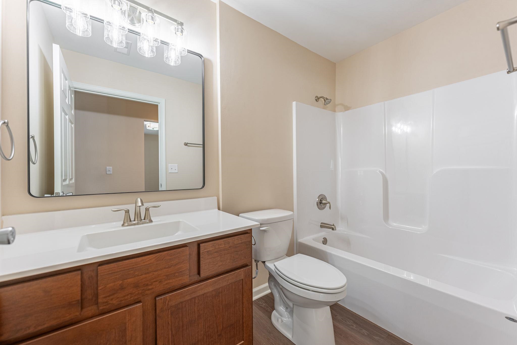 882 Fuller Lane Belvidere, IL 61008 - Photo 9 of 29 a bathroom with a sink a toilet and shower