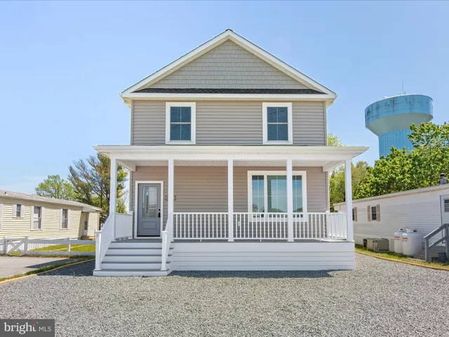 a view of a house with a yard and wooden fence