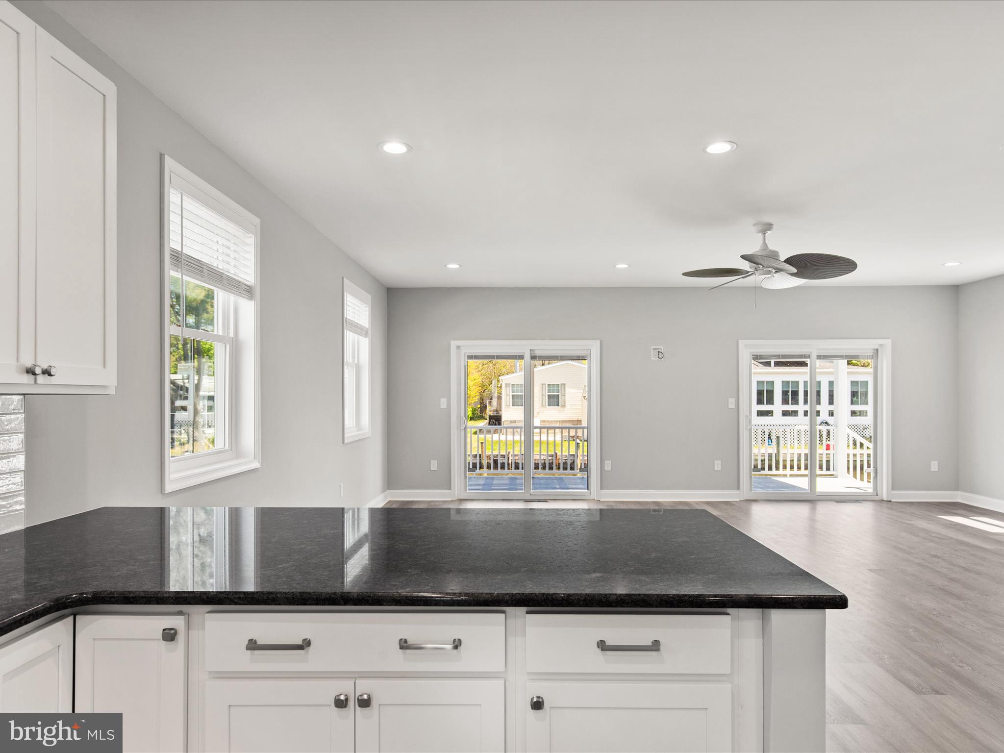 36986 Blue Teal Road Selbyville, DE 19975 - Photo 15 of 54 a kitchen with granite countertop a stove a sink and a window