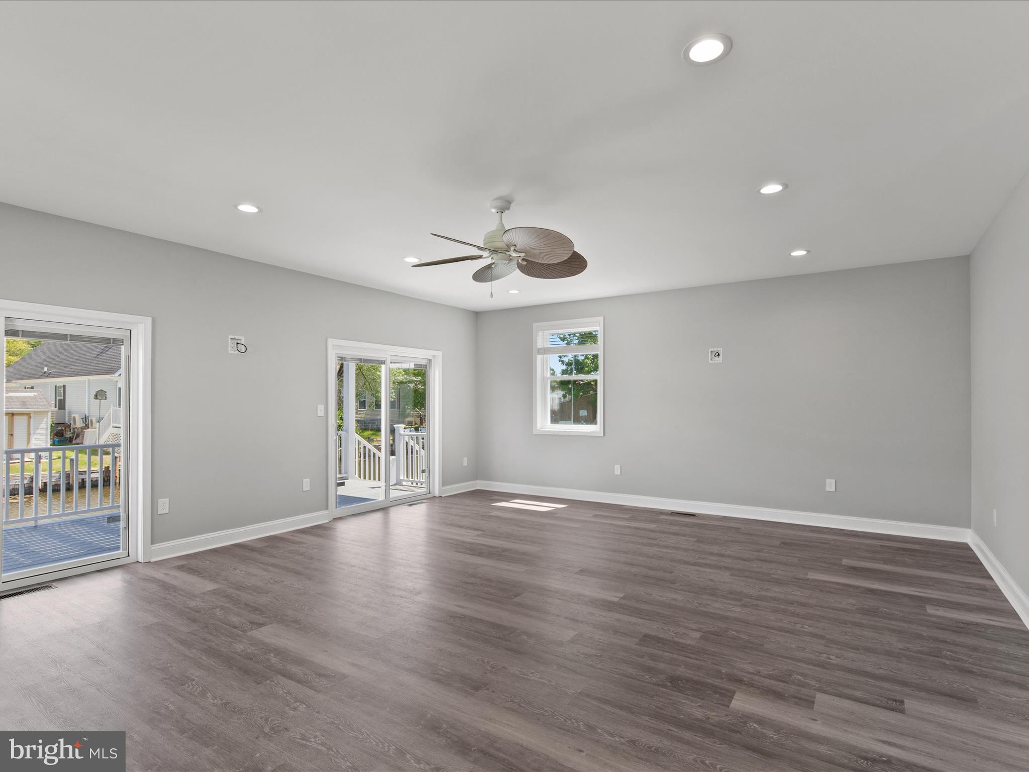36986 Blue Teal Road Selbyville, DE 19975 - Photo 16 of 54 a view of an empty room with wooden floor and a window