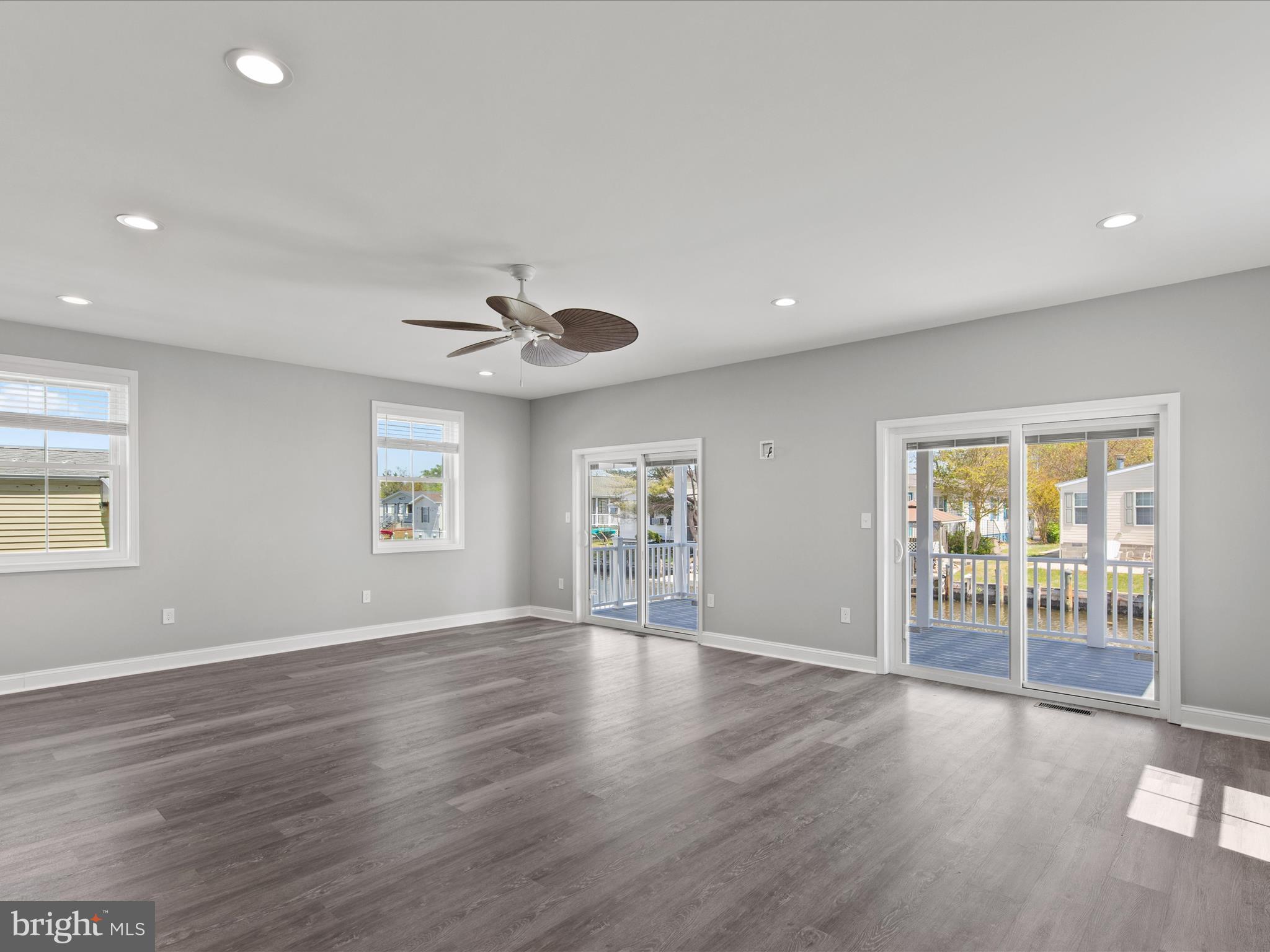 36986 Blue Teal Road Selbyville, DE 19975 - Photo 17 of 54 a view of an empty room with a window and wooden floor