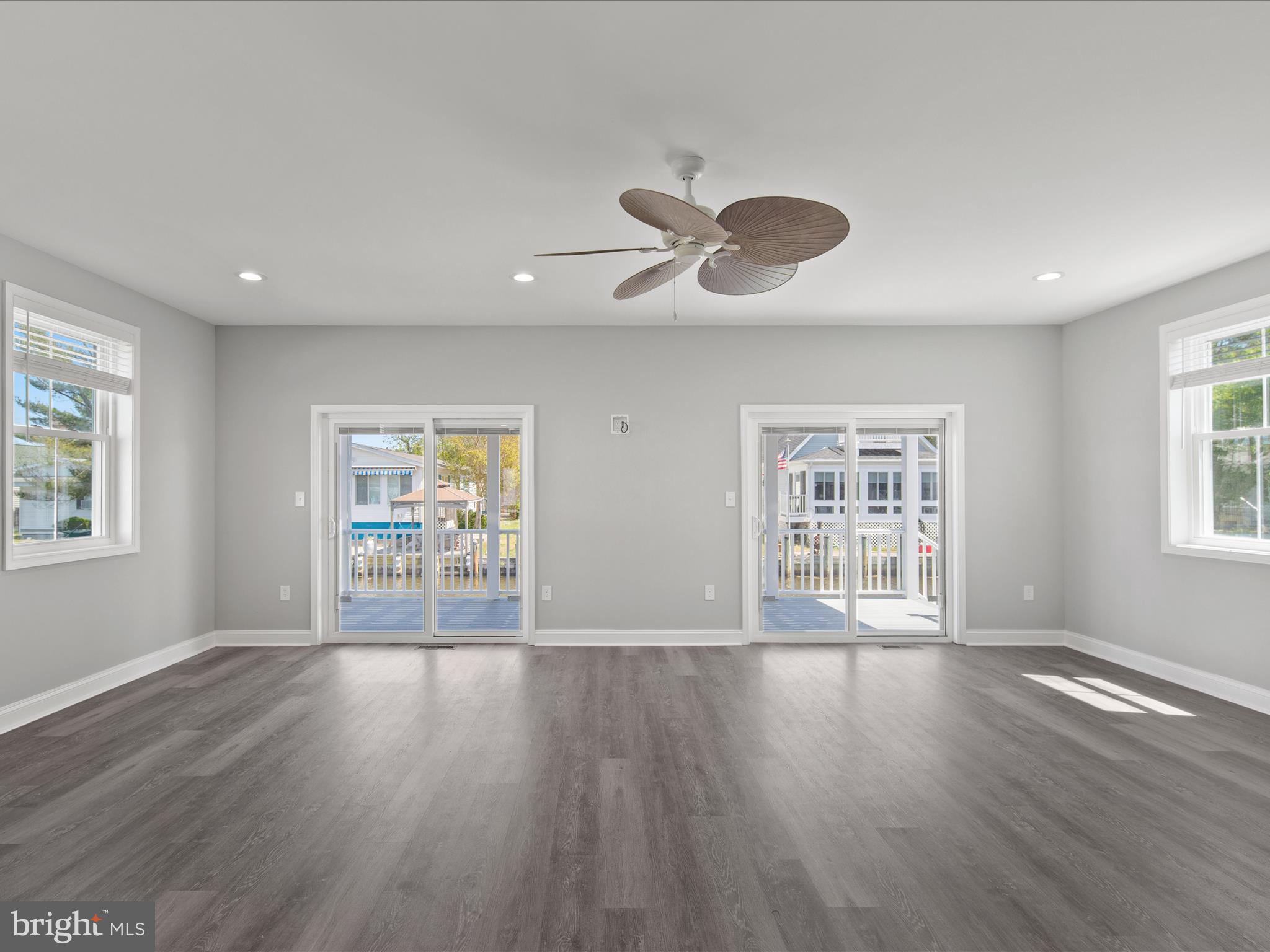 36986 Blue Teal Road Selbyville, DE 19975 - Photo 18 of 54 a view of an empty room with a window and wooden floor
