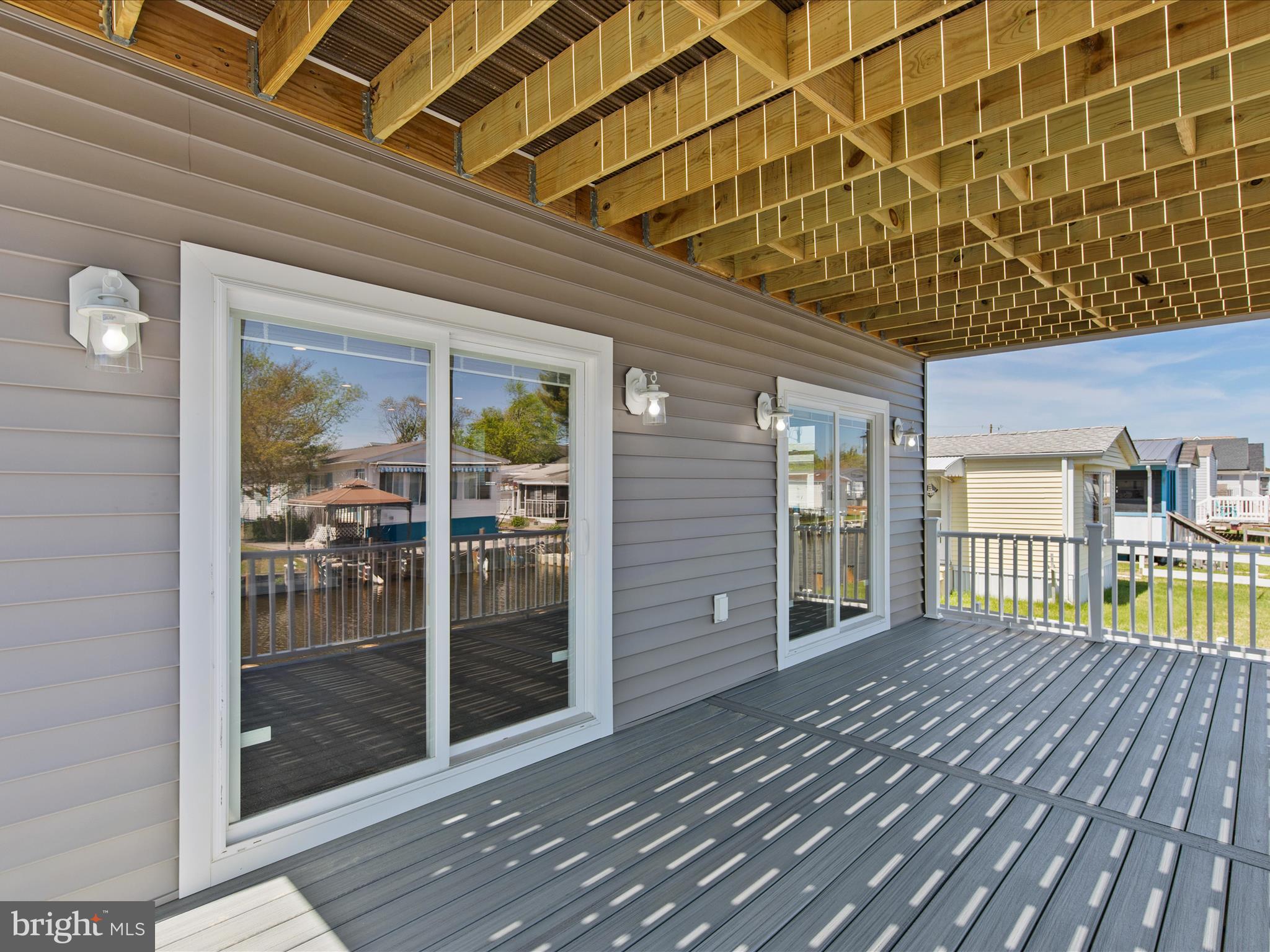 36986 Blue Teal Road Selbyville, DE 19975 - Photo 20 of 54 a balcony view with a glass door