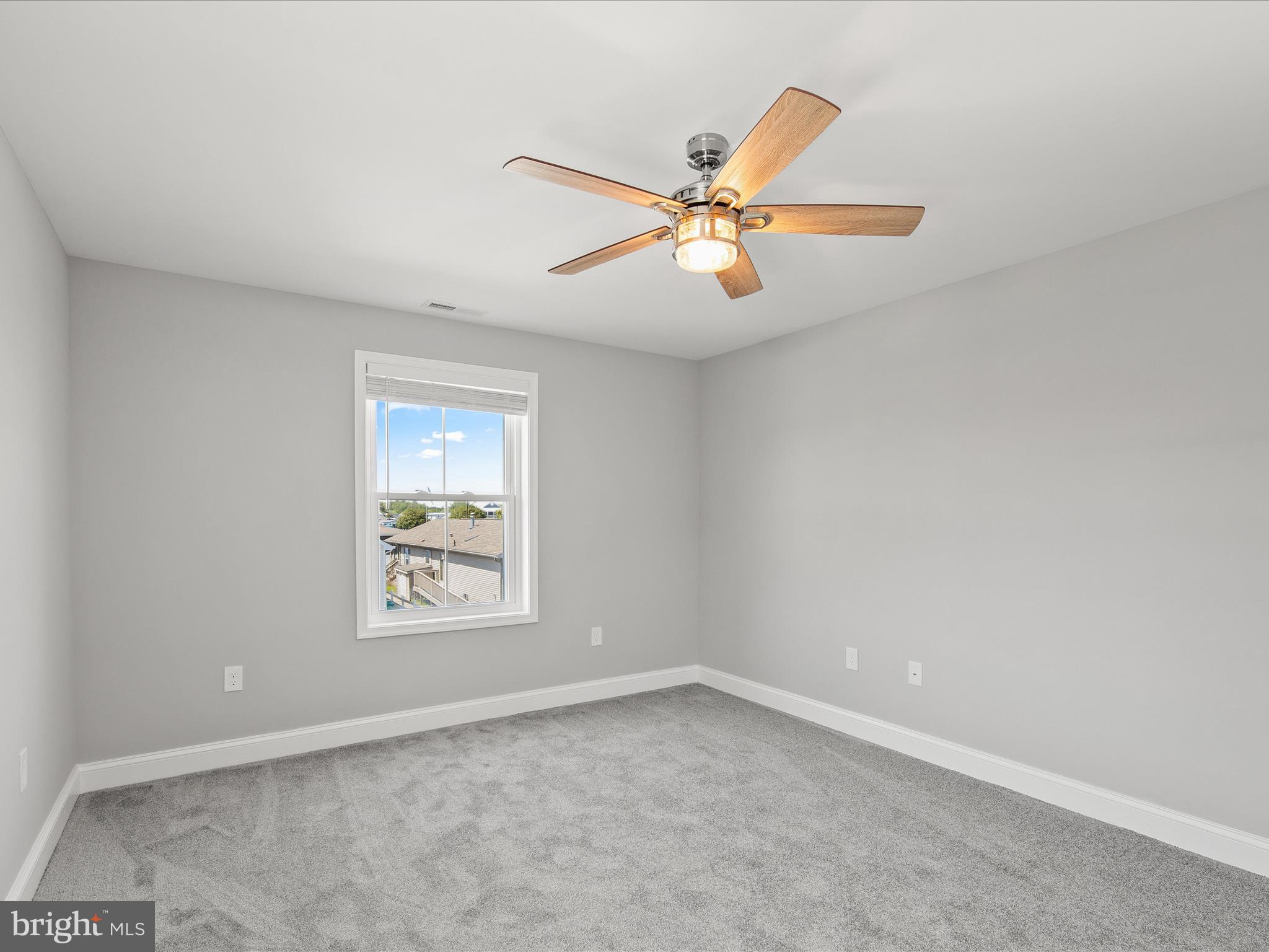 36986 Blue Teal Road Selbyville, DE 19975 - Photo 22 of 54 an empty room with a window and a fan