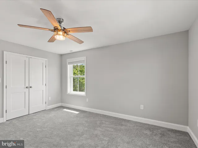 a bathroom with a granite countertop sink toilet a mirror and shower