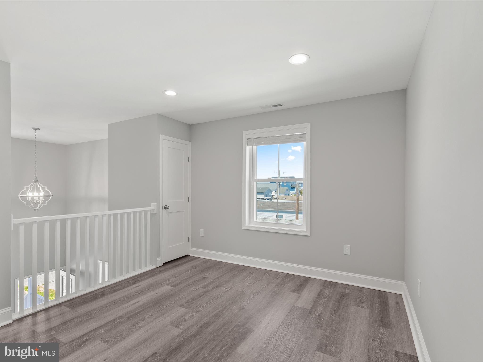 36986 Blue Teal Road Selbyville, DE 19975 - Photo 28 of 54 an empty room with wooden floor and windows