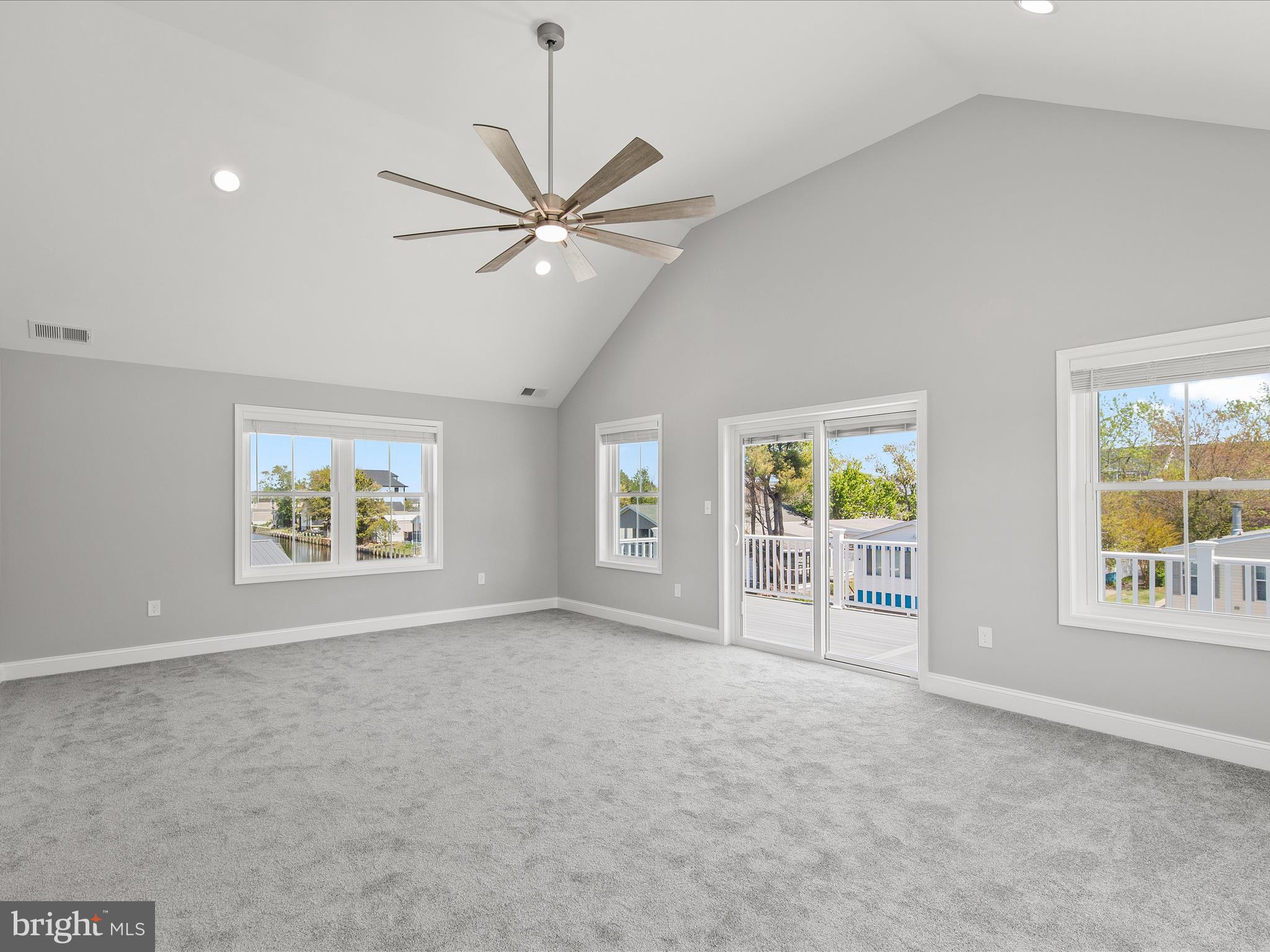 36986 Blue Teal Road Selbyville, DE 19975 - Photo 31 of 54 a view of an empty room with a window and a kitchen