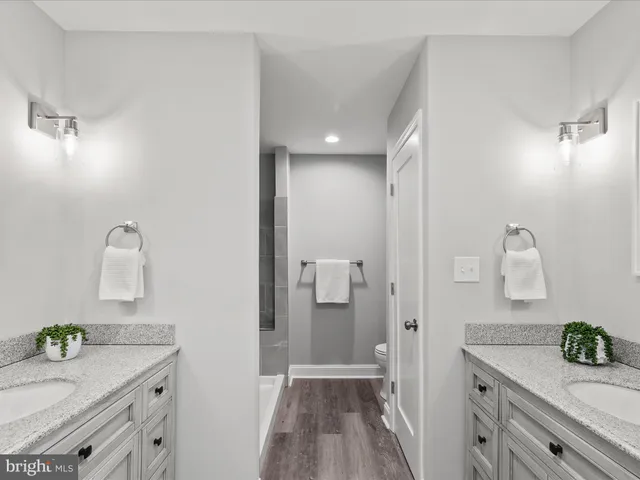 a view of an empty room and chandelier fan