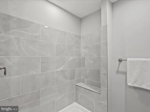 a bathroom with a granite countertop sink a toilet and shower