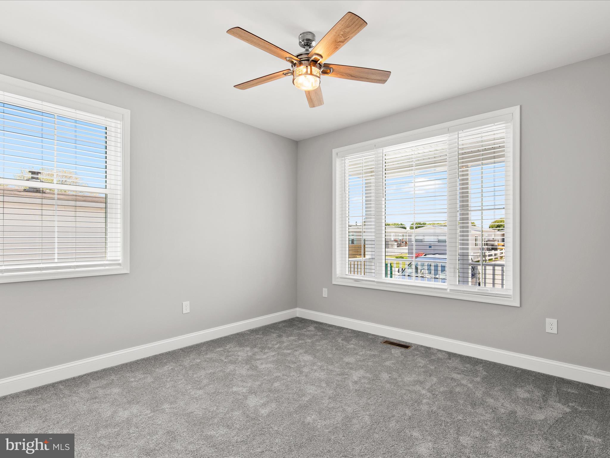 36986 Blue Teal Road Selbyville, DE 19975 - Photo 40 of 54 an empty room with windows and fan