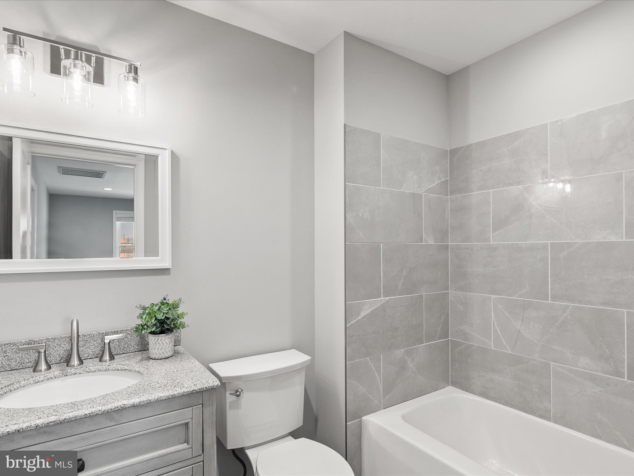 36986 Blue Teal Road Selbyville, DE 19975 - Photo 42 of 54 a bathroom with a granite countertop sink a toilet and shower