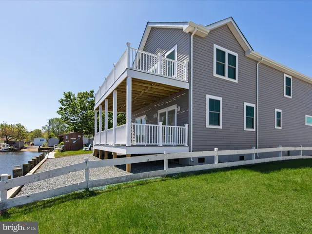 a view of a house with swimming pool and sitting area