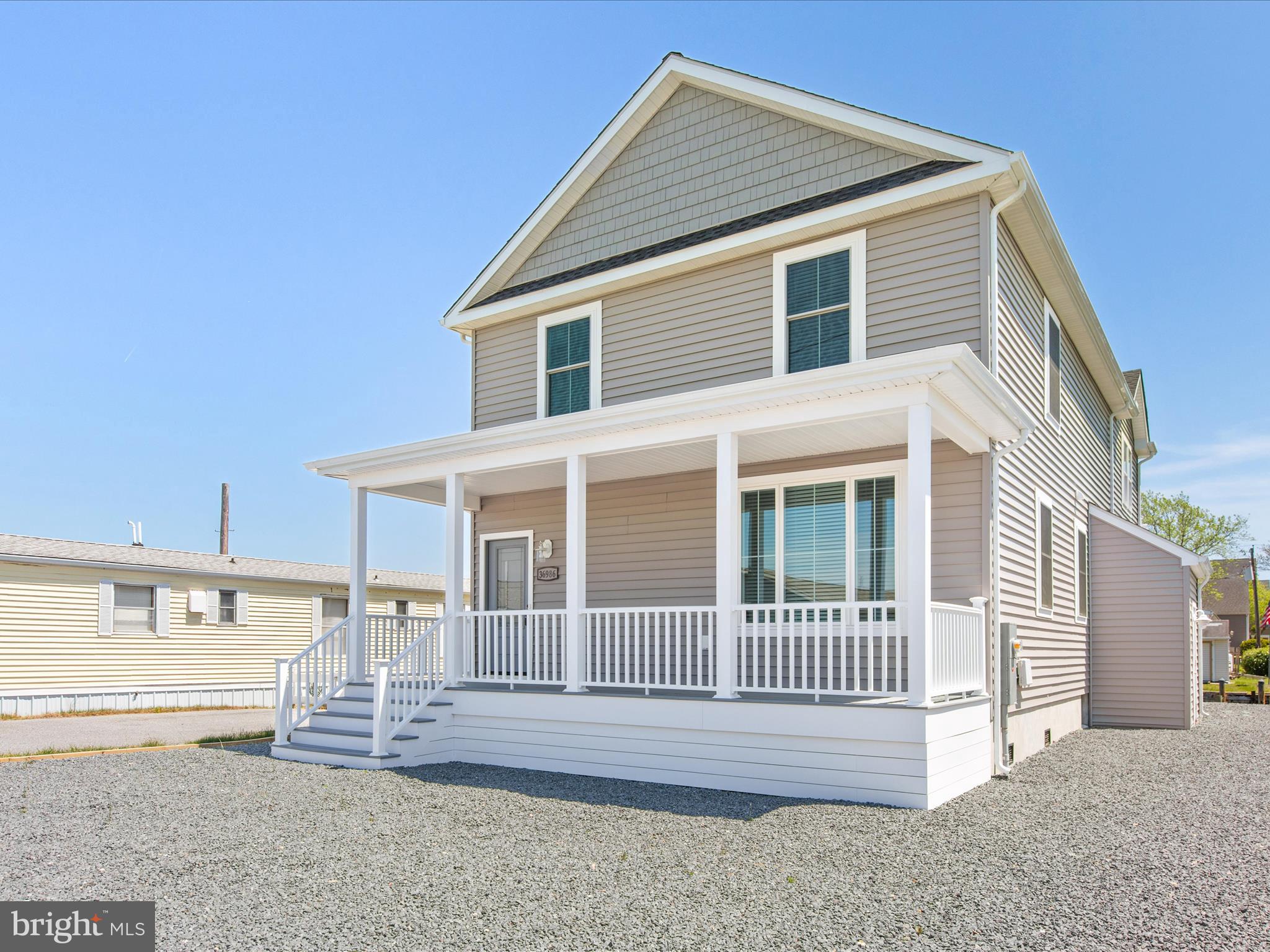 36986 Blue Teal Road Selbyville, DE 19975 - Photo 5 of 54 a front view of a house with a yard