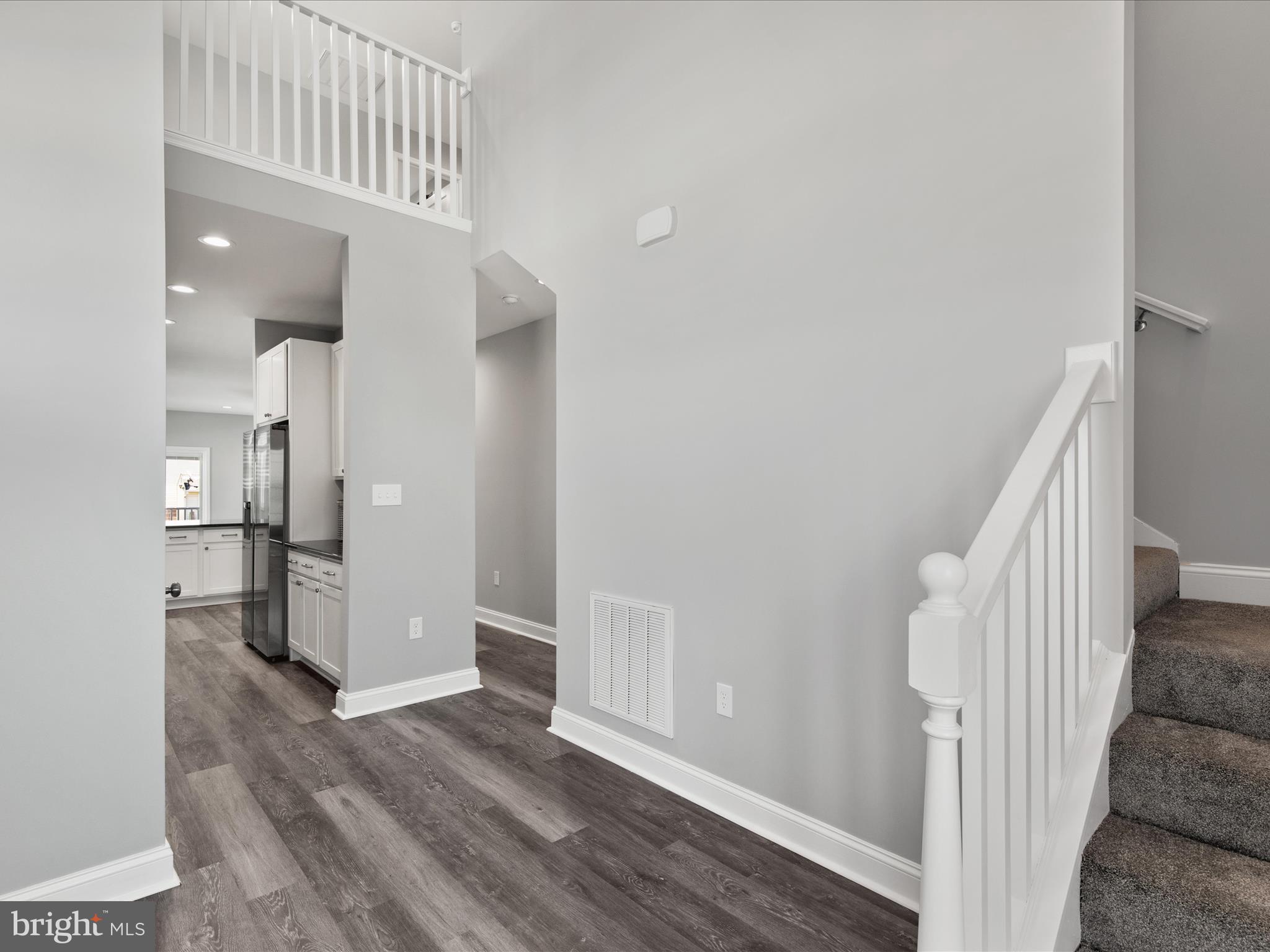 36986 Blue Teal Road Selbyville, DE 19975 - Photo 8 of 54 a view of a hallway with wooden floor and entryway