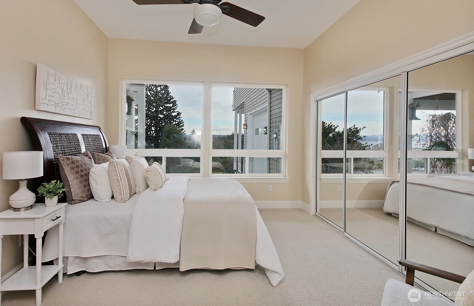 4694 Wrightsman Place Clinton, WA 98236 - Photo 27 of 38 a bedroom with a large bed and a large window