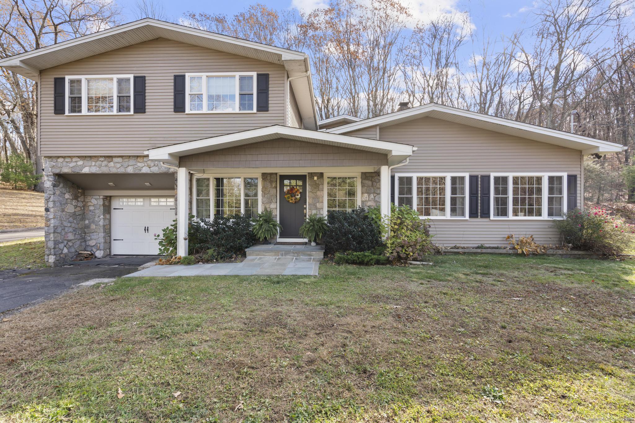 115 Old Wolcott Road Bristol, CT 06010 - Photo 1 of 23 a front view of a house with a yard and trees