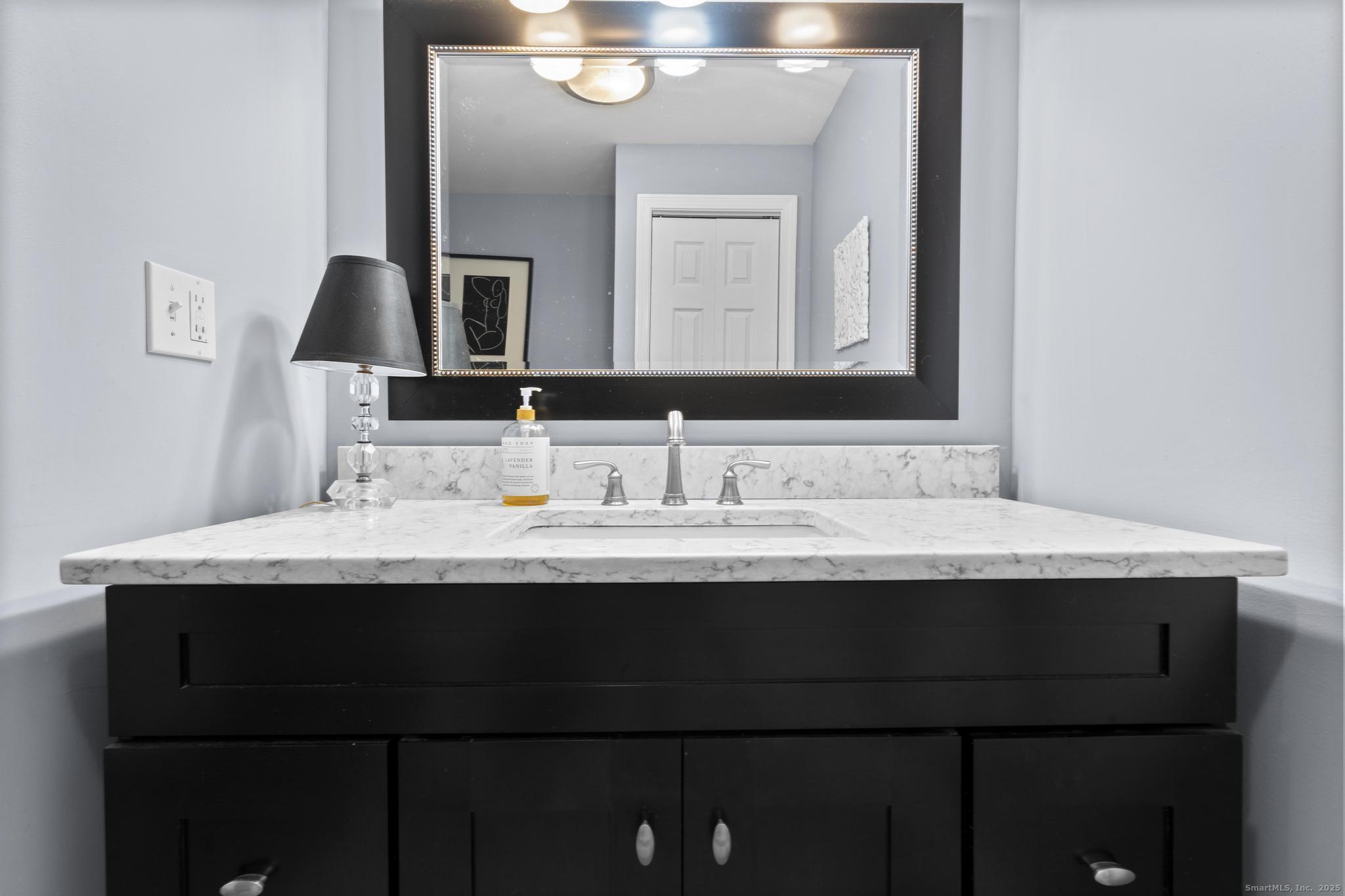 115 Old Wolcott Road Bristol, CT 06010 - Photo 12 of 23 a bathroom with a granite countertop sink and a mirror