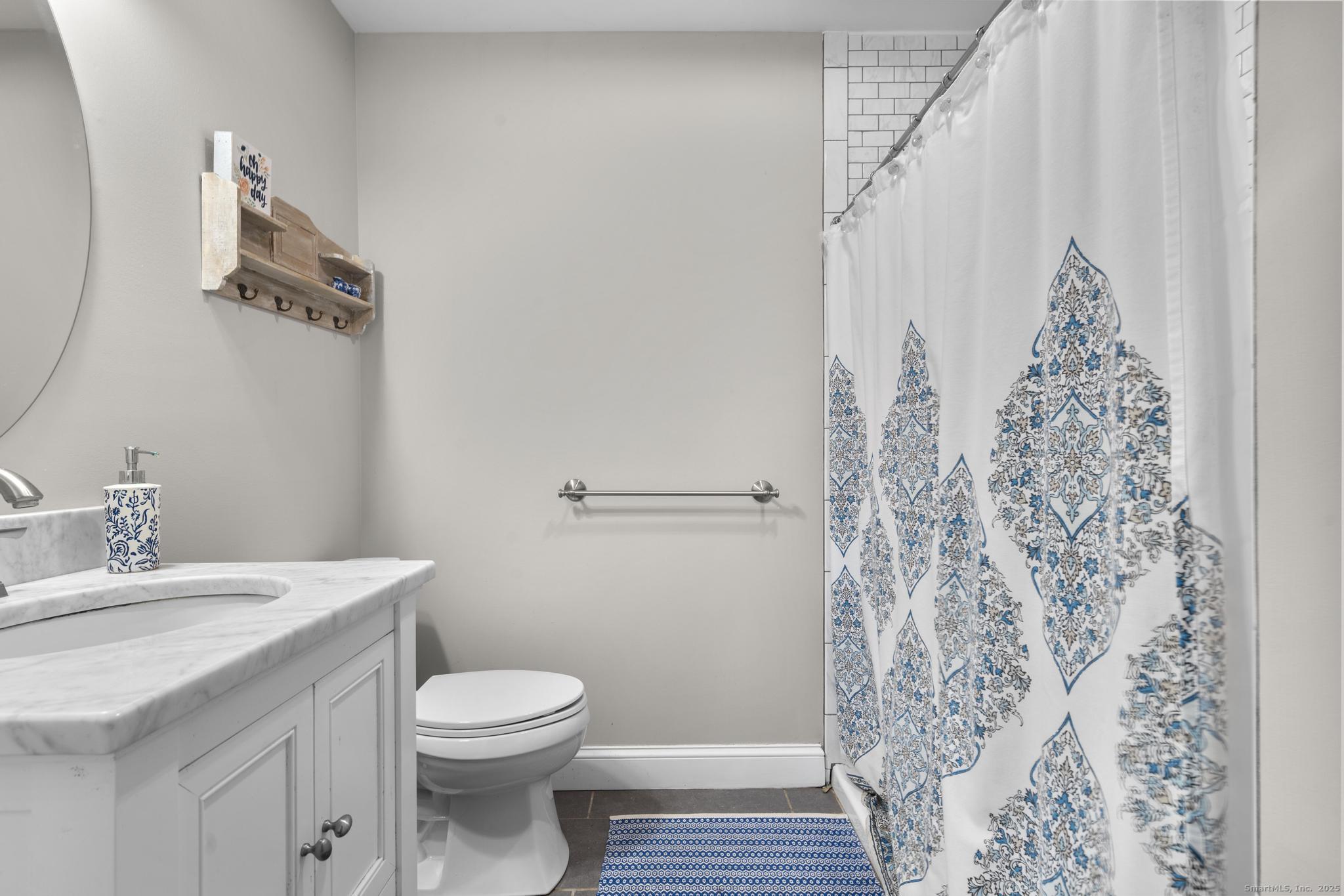 115 Old Wolcott Road Bristol, CT 06010 - Photo 14 of 23 a bathroom with a sink a toilet and shower curtain