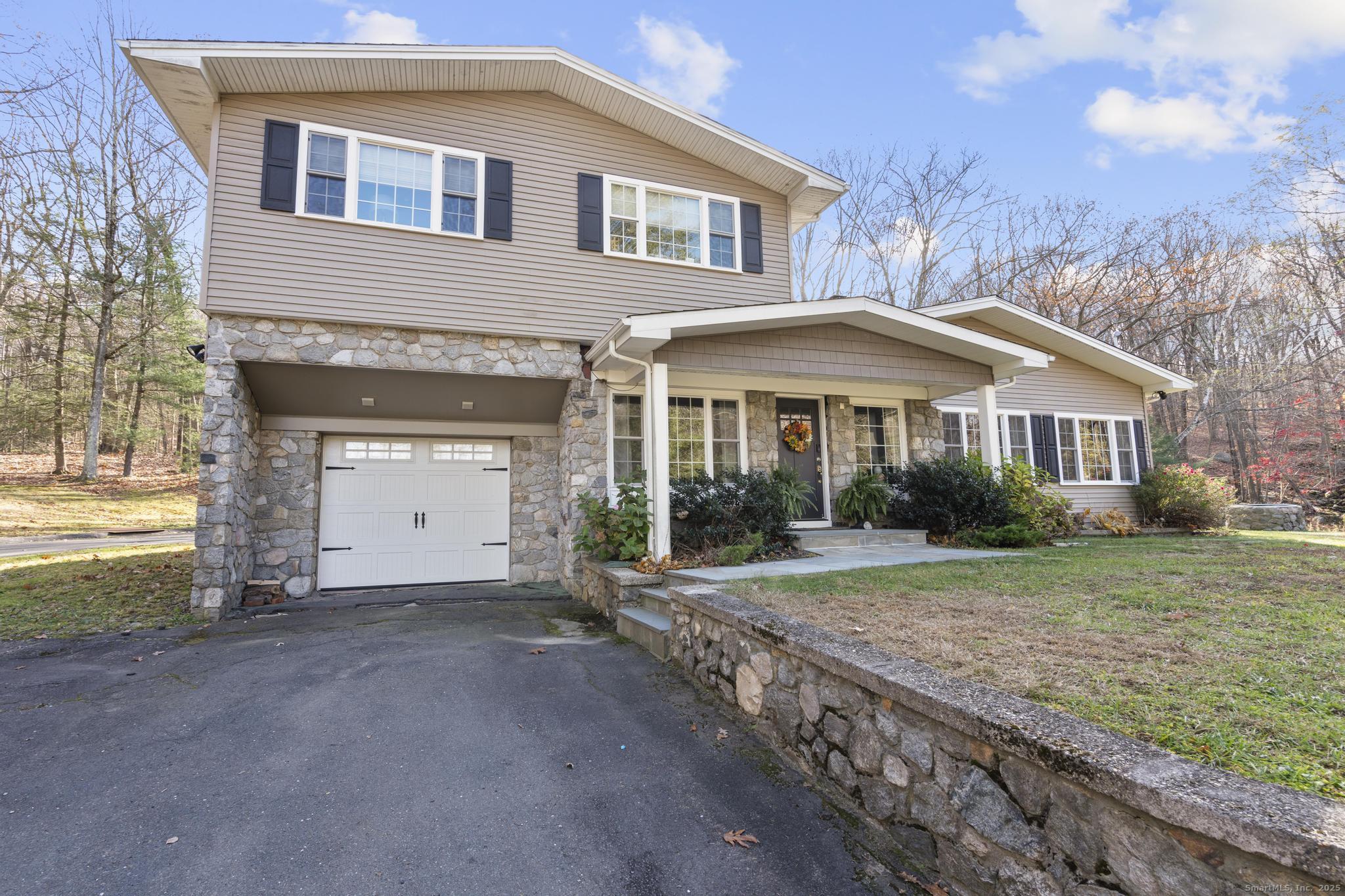 115 Old Wolcott Road Bristol, CT 06010 - Photo 2 of 23 a front view of a house with a yard and garage