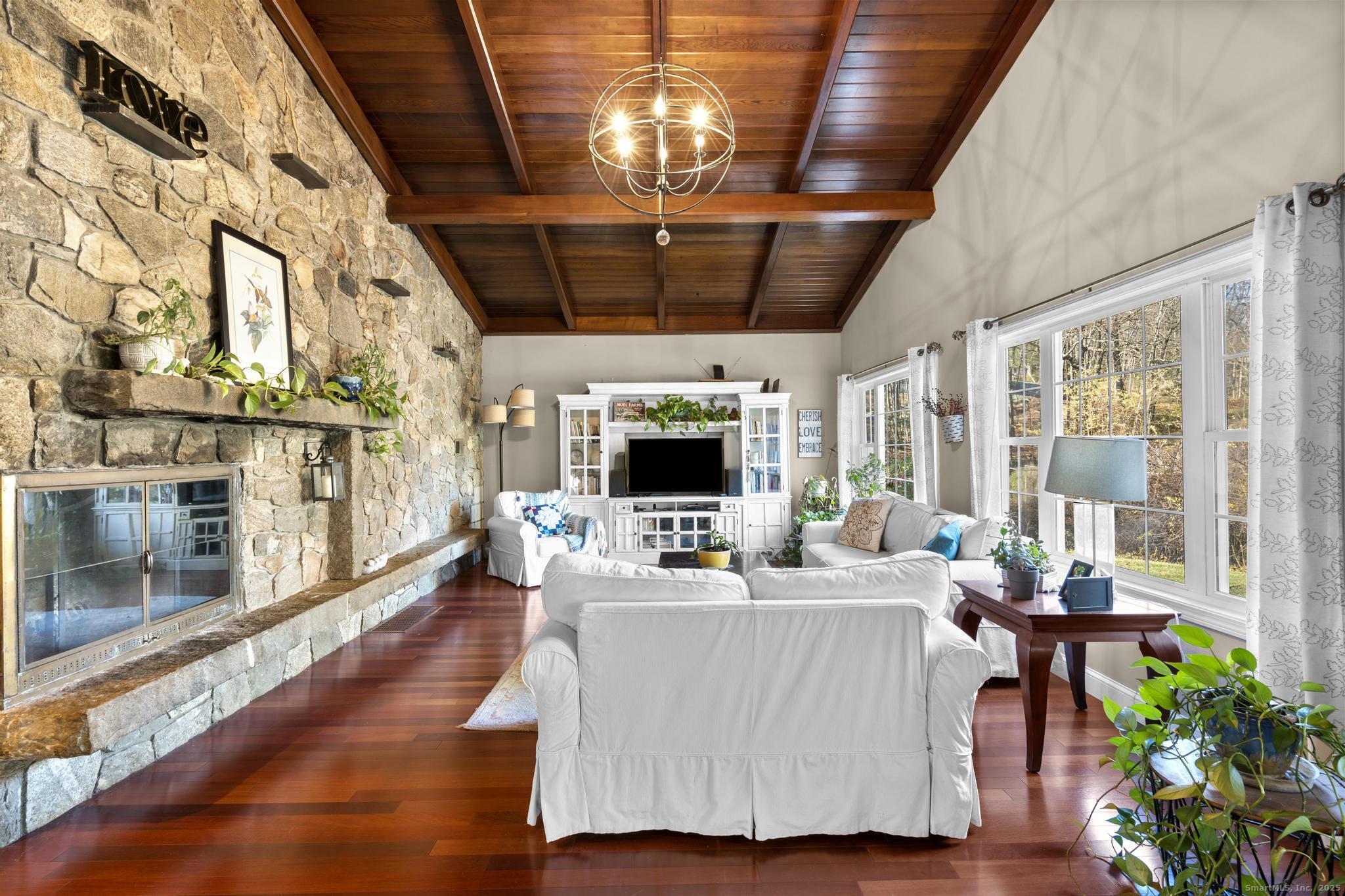 115 Old Wolcott Road Bristol, CT 06010 - Photo 5 of 23 a living room with lots of furniture and a chandelier