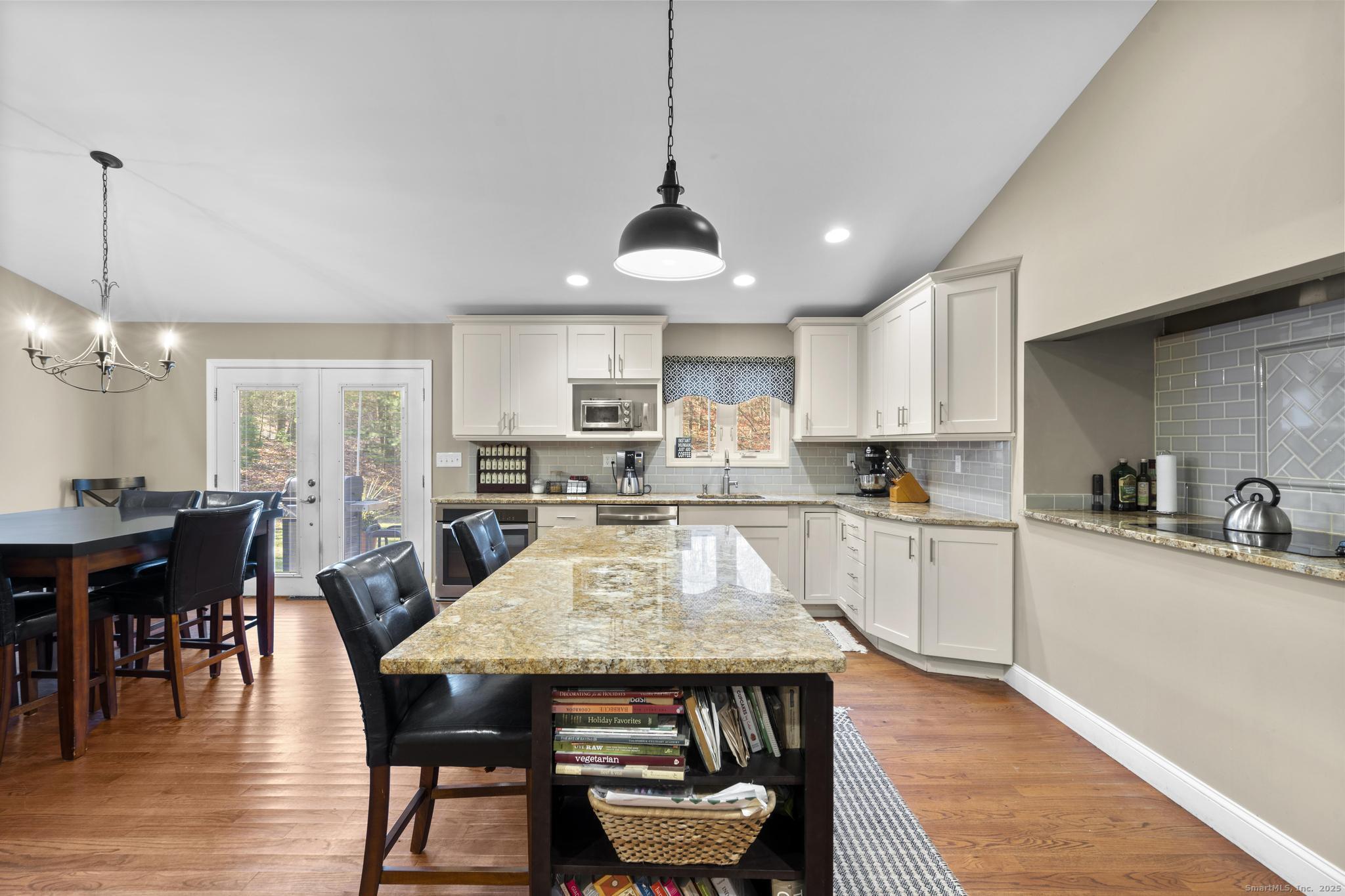 115 Old Wolcott Road Bristol, CT 06010 - Photo 9 of 23 a large kitchen with granite countertop lots of counter space dining table and stainless steel appliances
