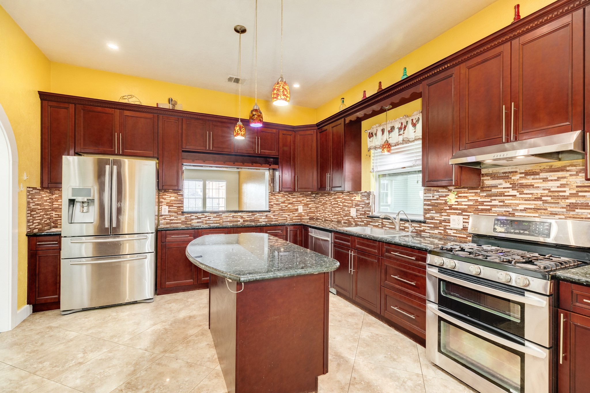 1625 Ave M 1/2 Galveston, TX 77550 - Photo 12 of 24 a kitchen with stainless steel appliances granite countertop a sink a stove and a refrigerator