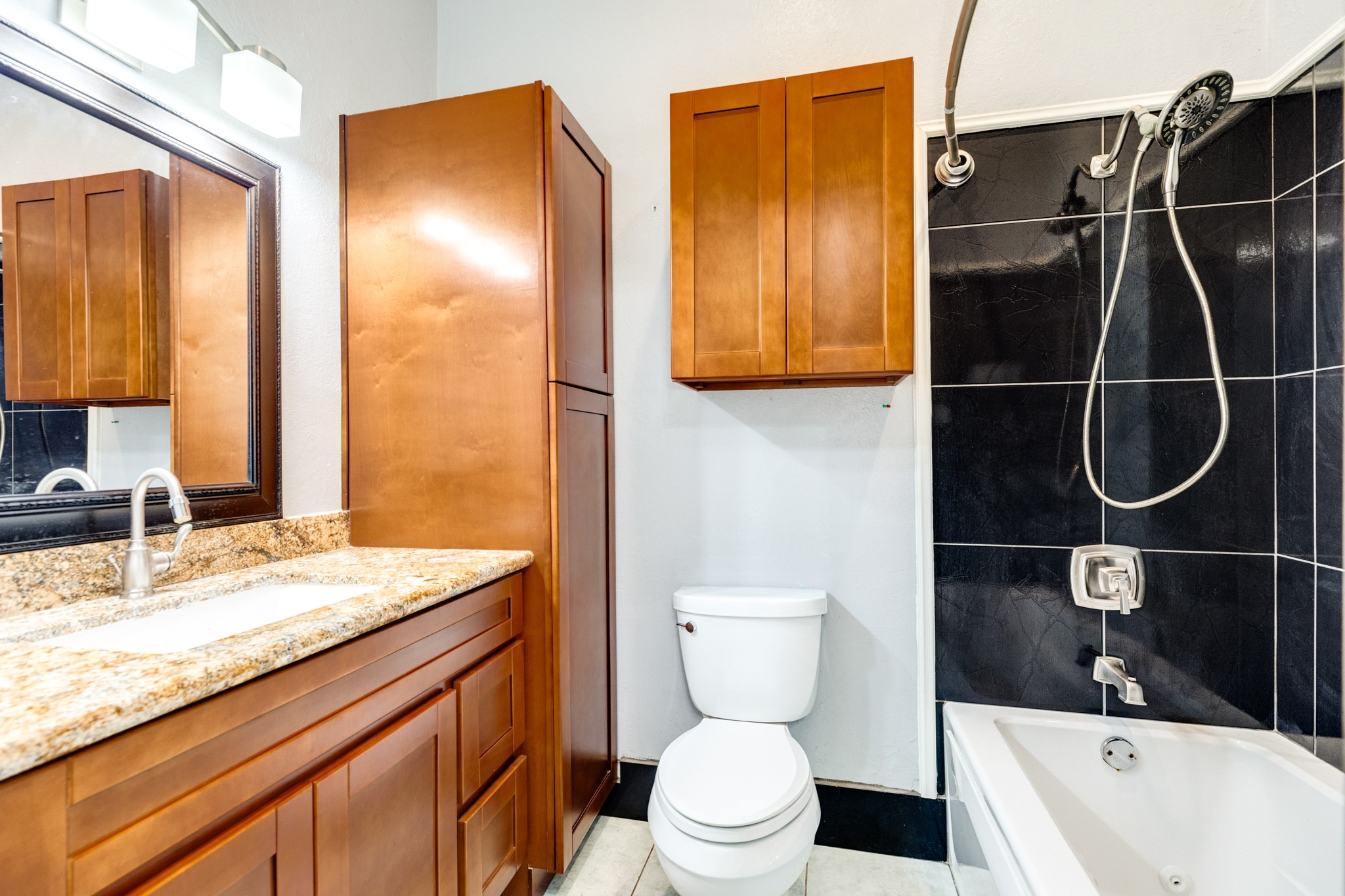 1625 Ave M 1/2 Galveston, TX 77550 - Photo 24 of 24 a bathroom with a granite countertop sink toilet and shower